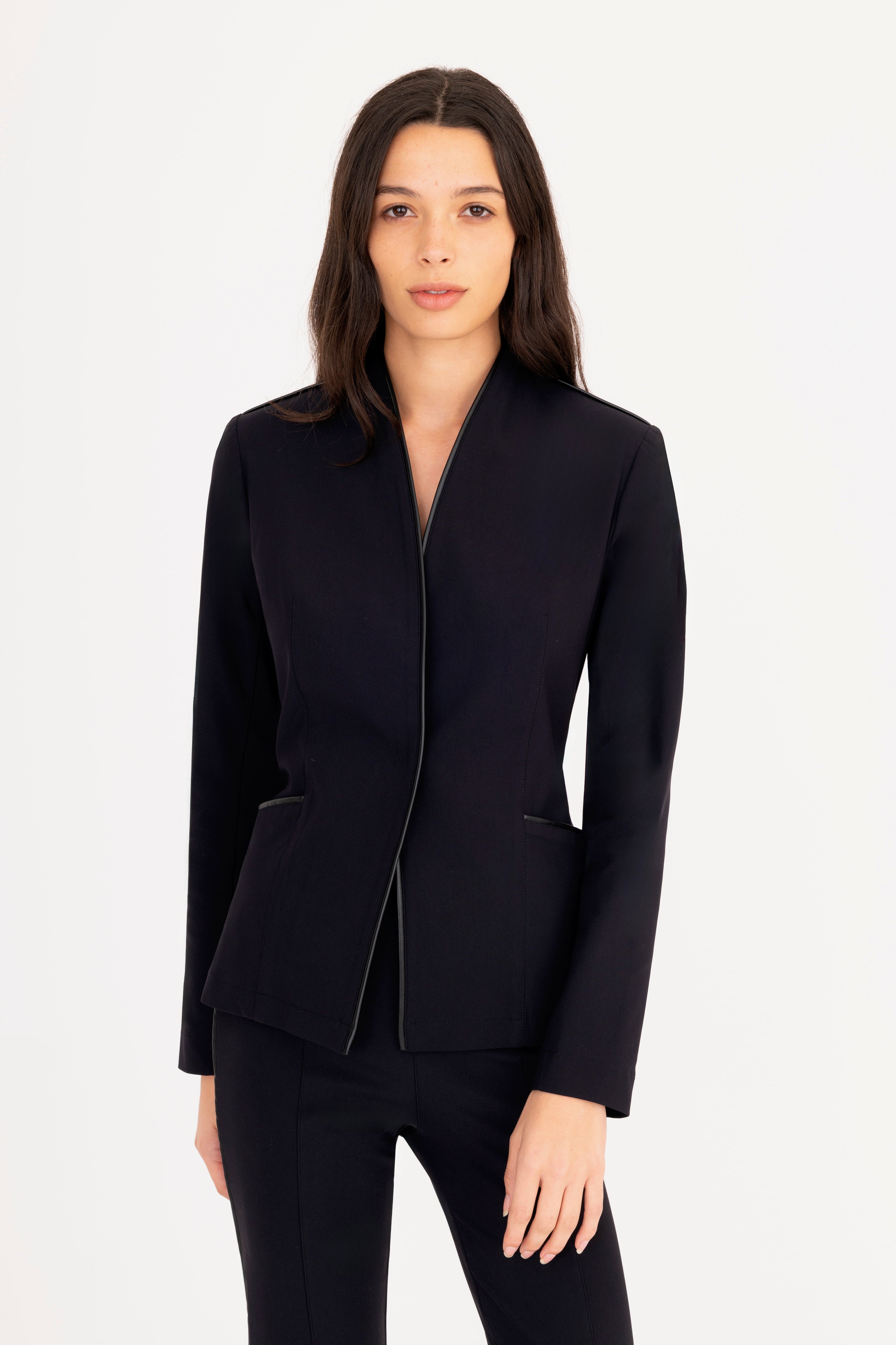 Woman wearing a black blazer on a white background