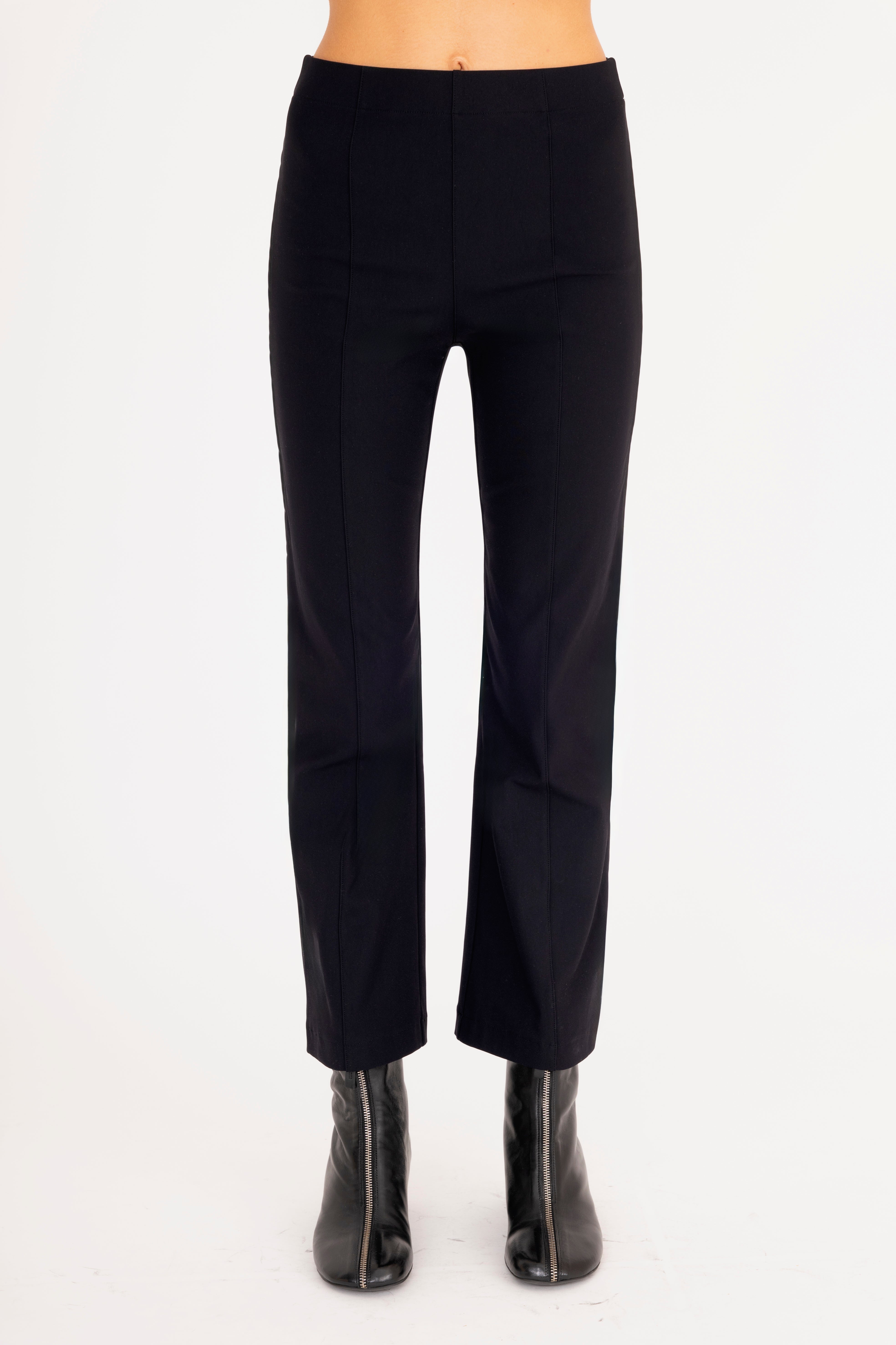 Black pants worn by a person on a white background