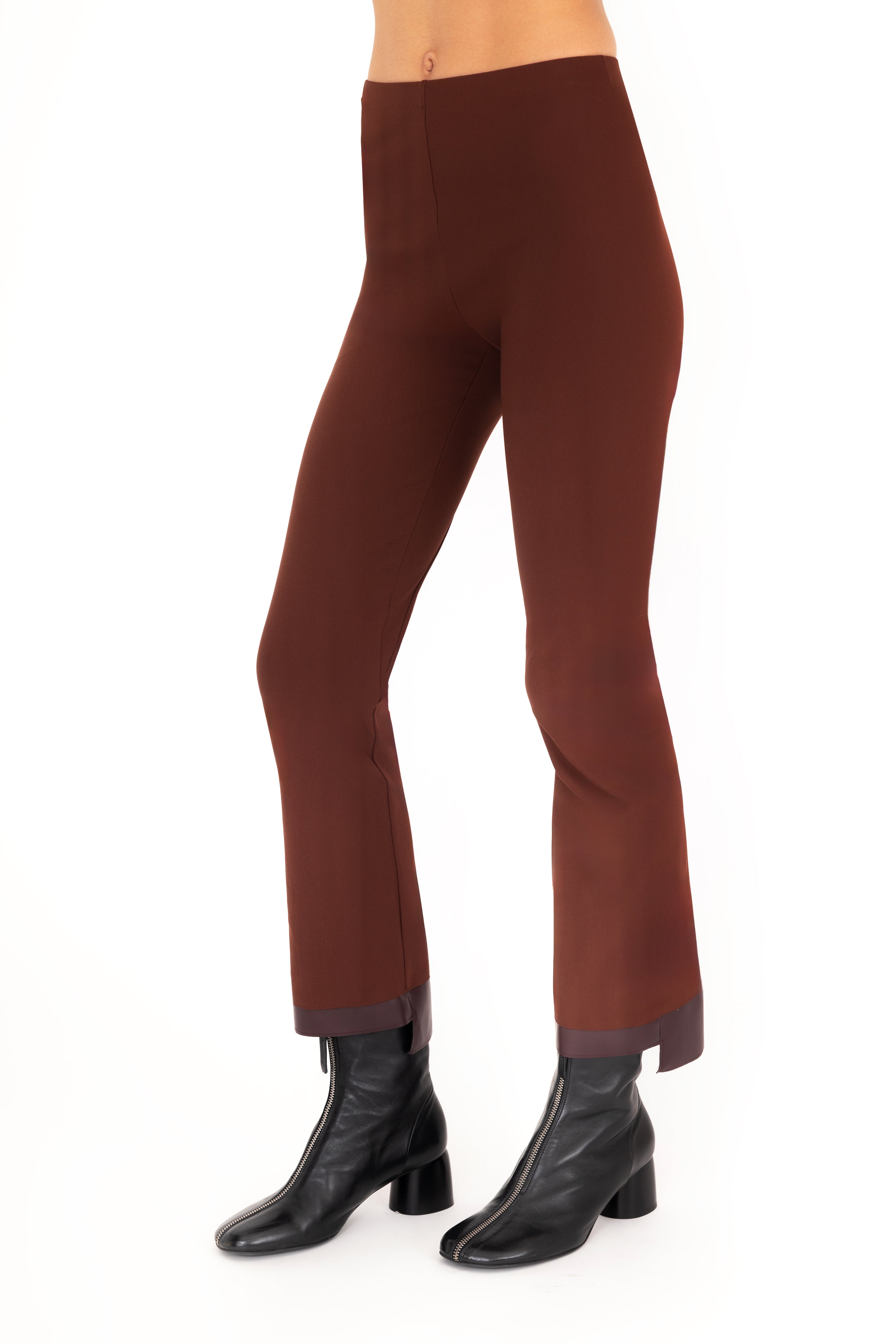 Brown pants worn by a person on a white background