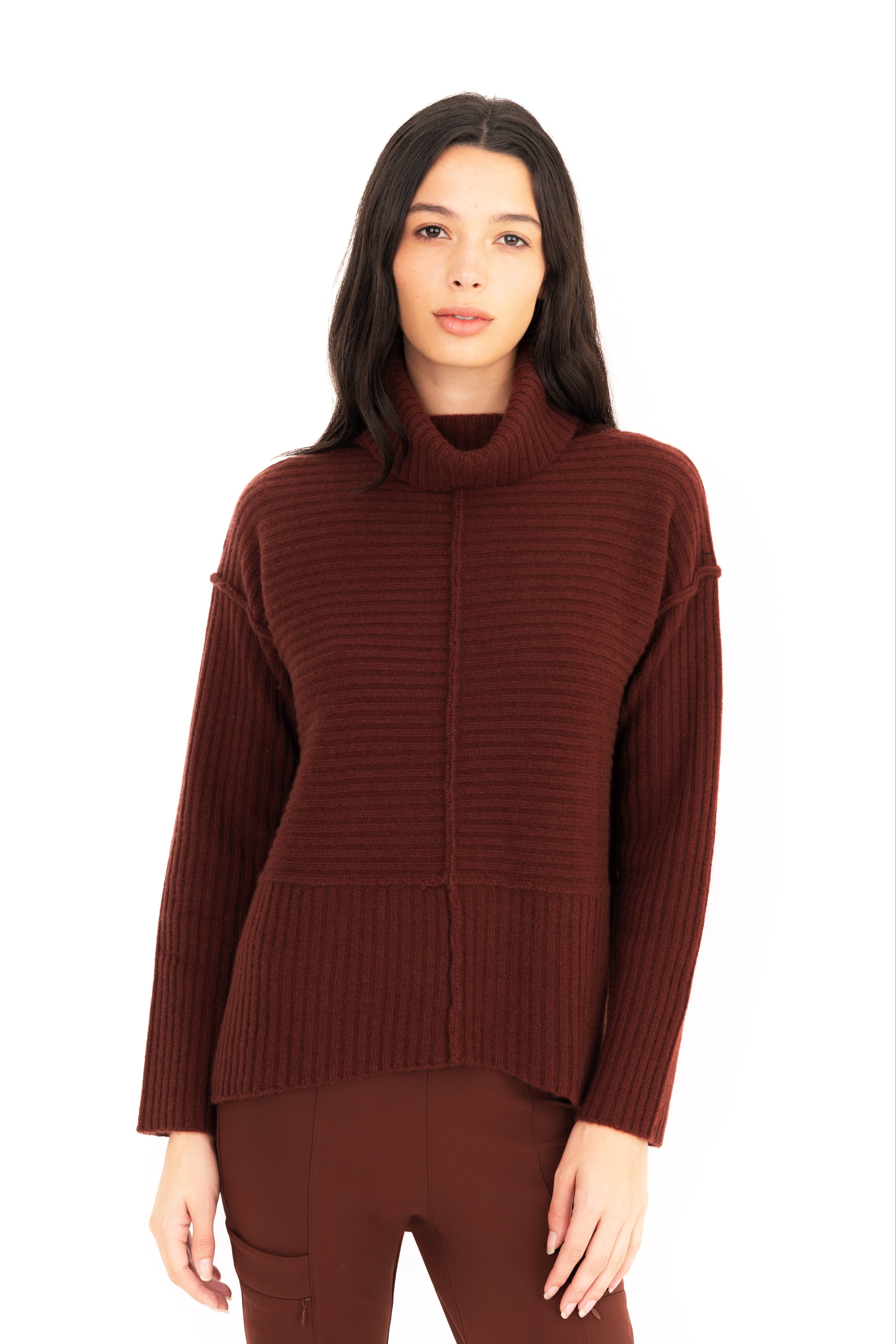 Woman wearing a brown ribbed sweater on a white background