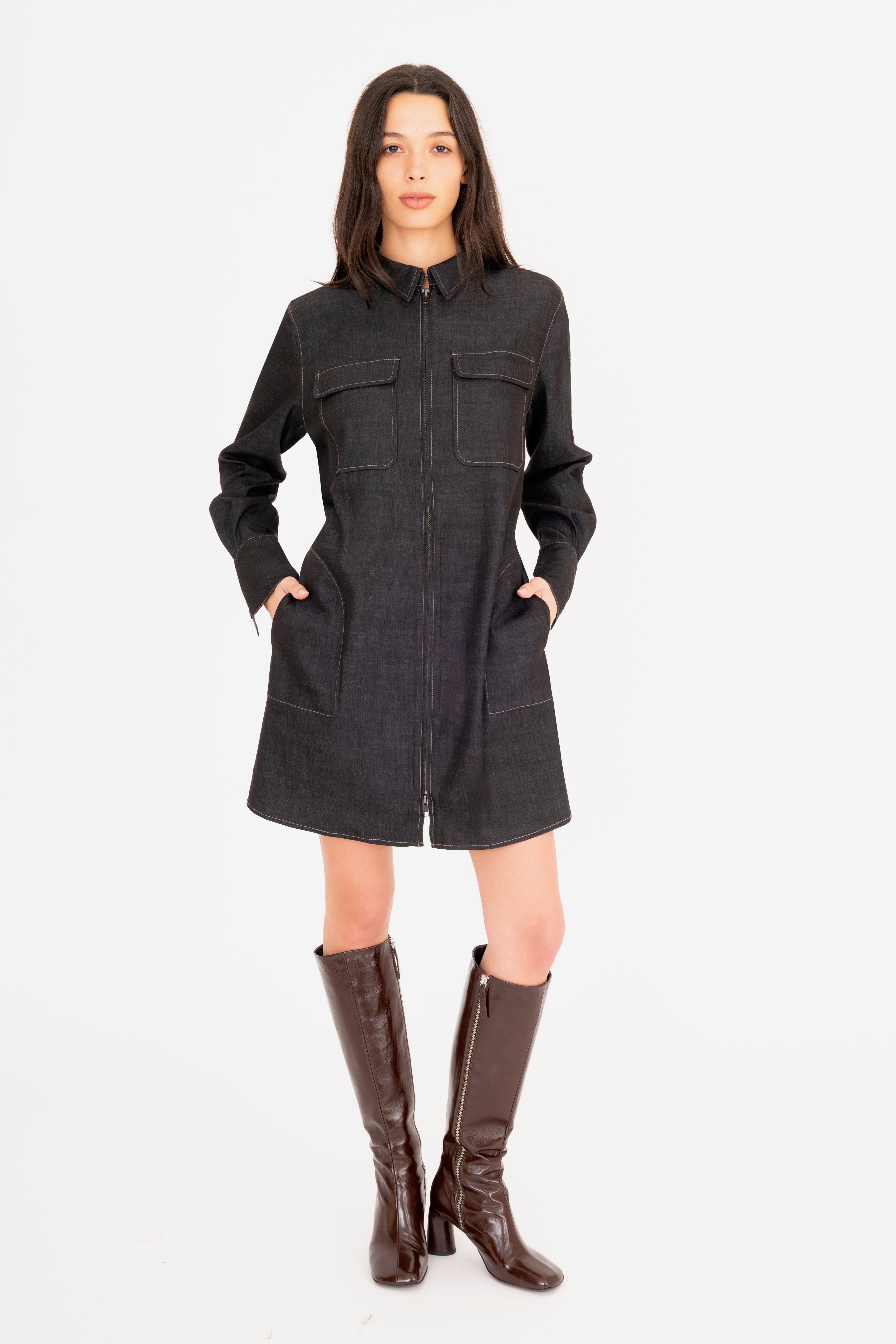 Woman wearing a dark gray dress with a white background