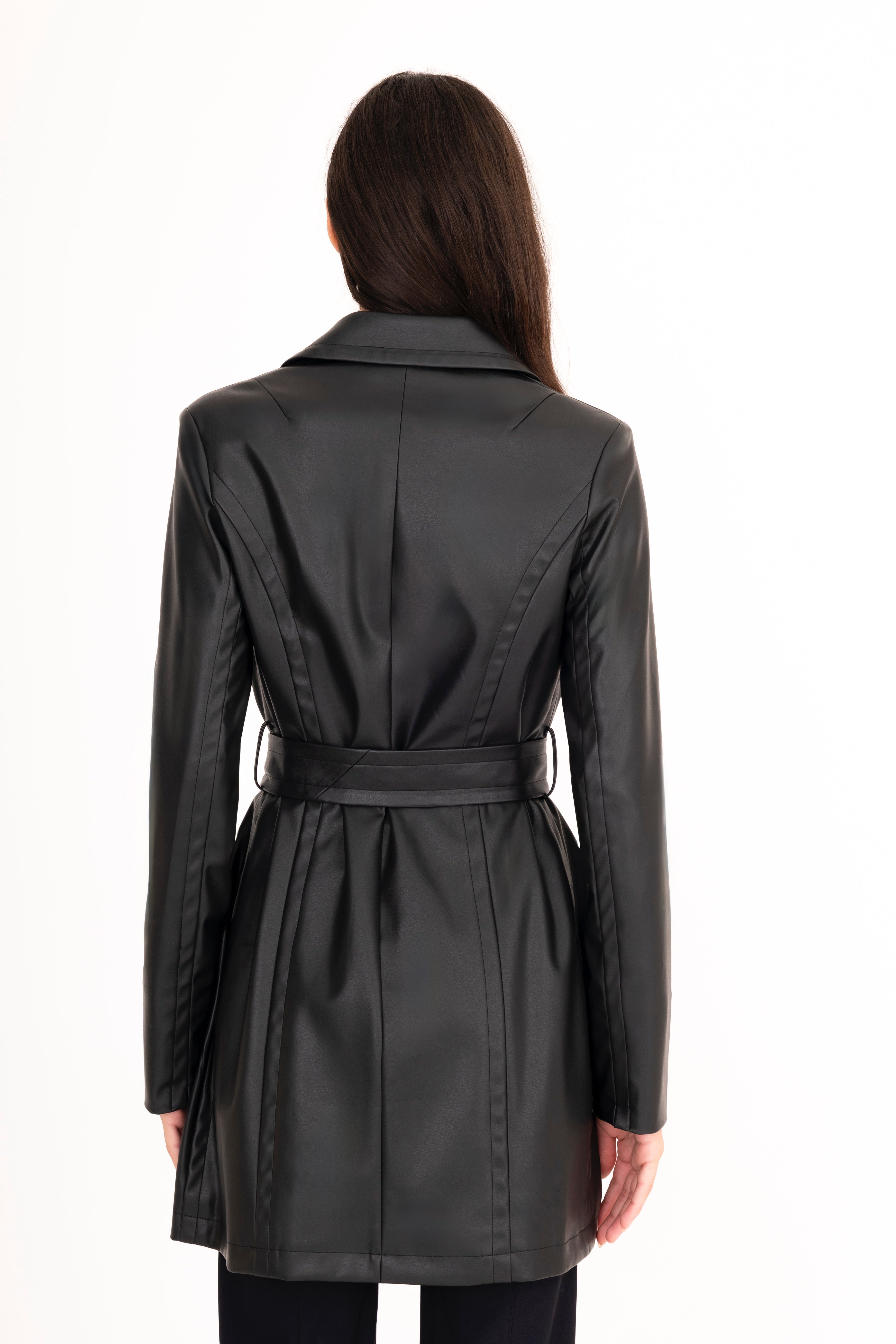 Black trench coat worn by a person on a white background