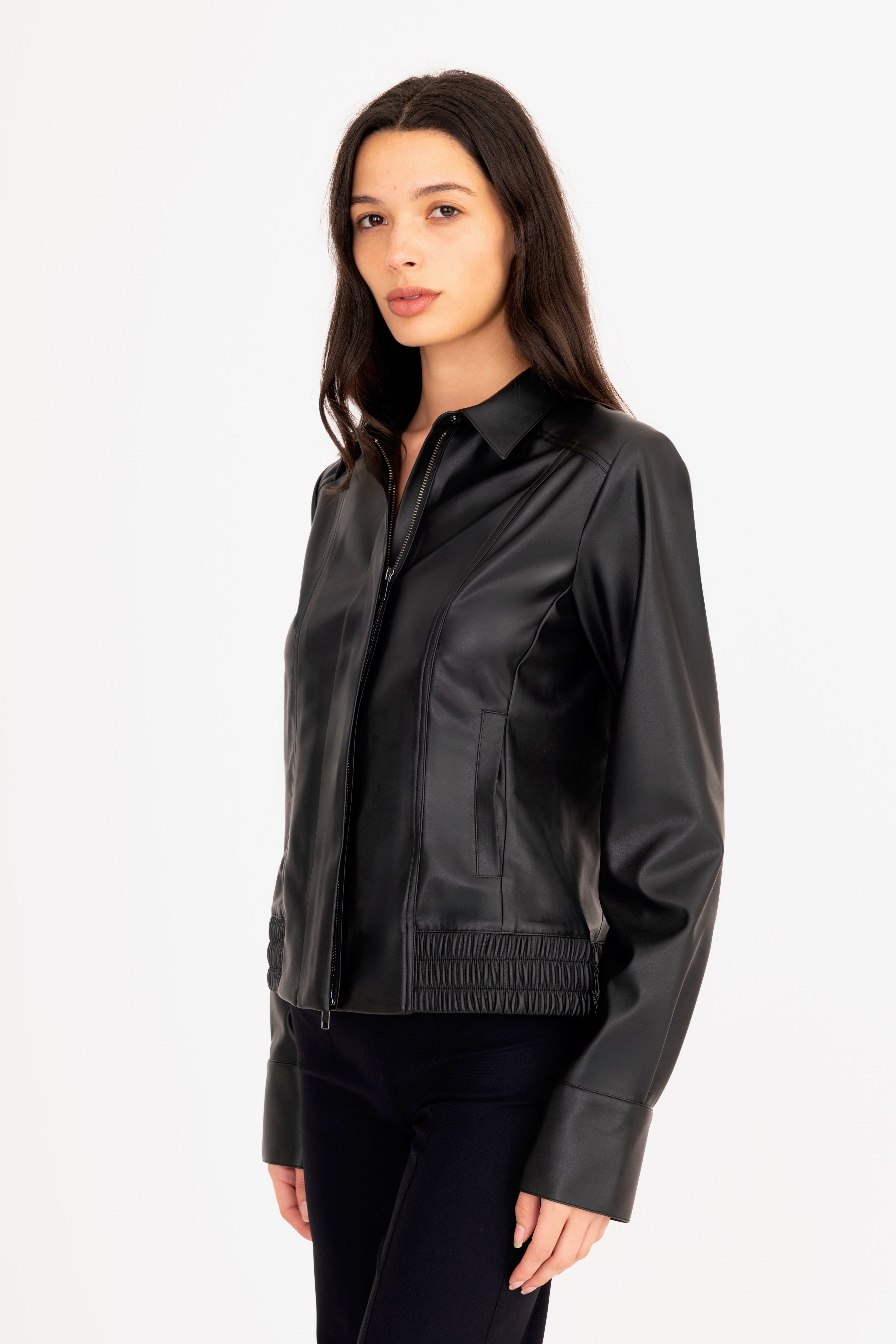 Woman wearing a black leather jacket on a white background