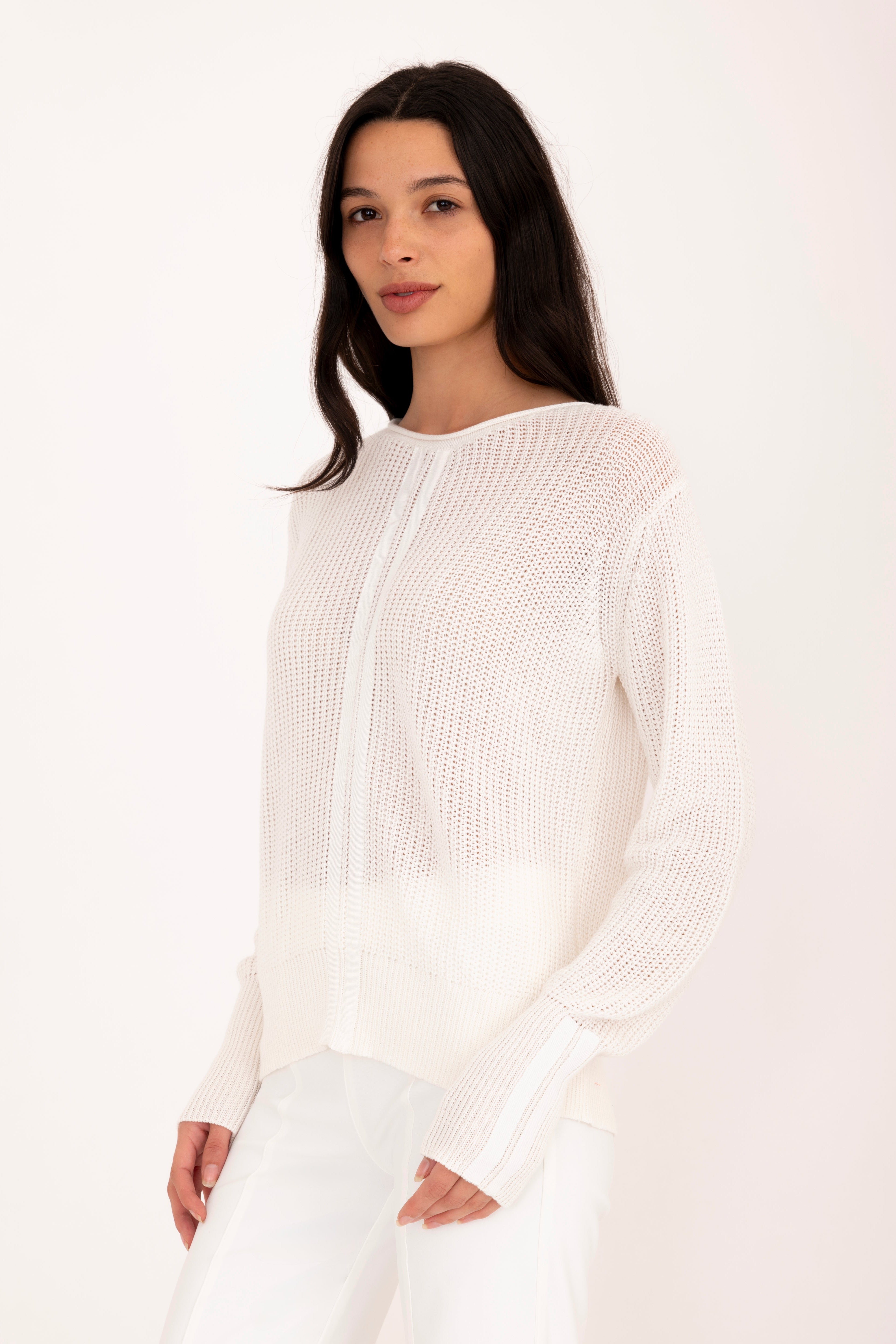 Woman wearing a white sweater on a white background