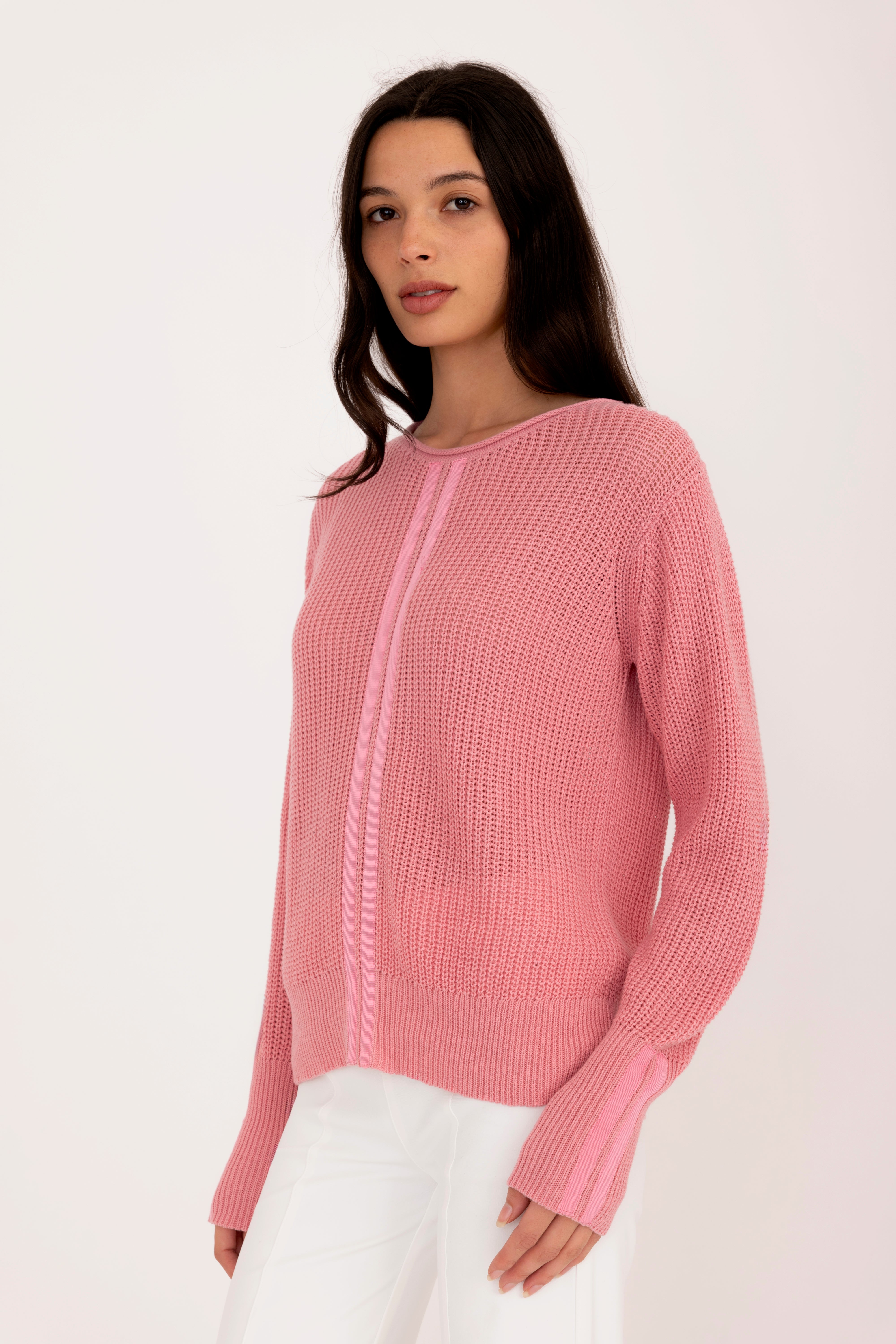 Woman wearing a pink sweater on a white background