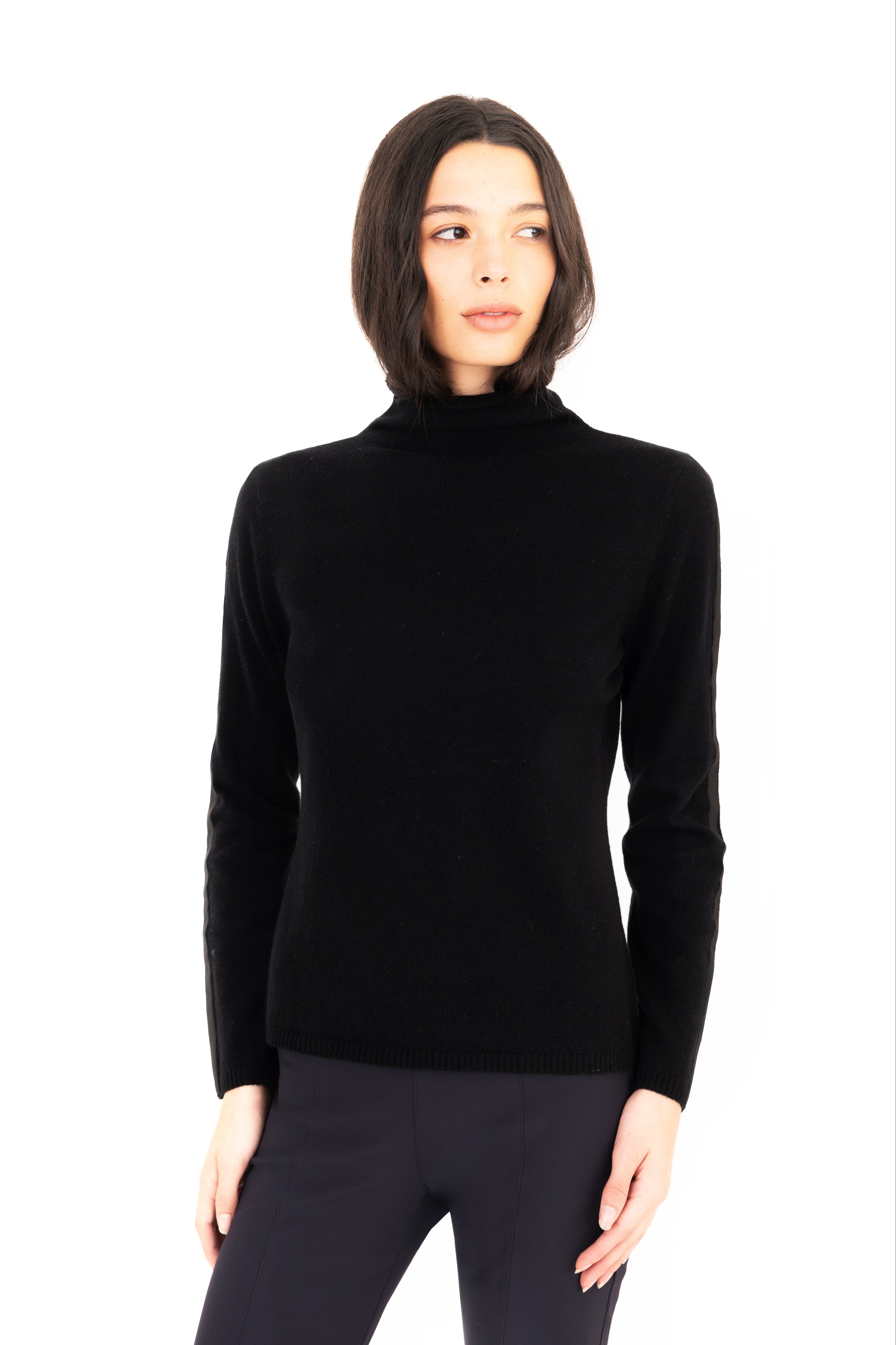 Woman wearing a black turtleneck sweater on a white background
