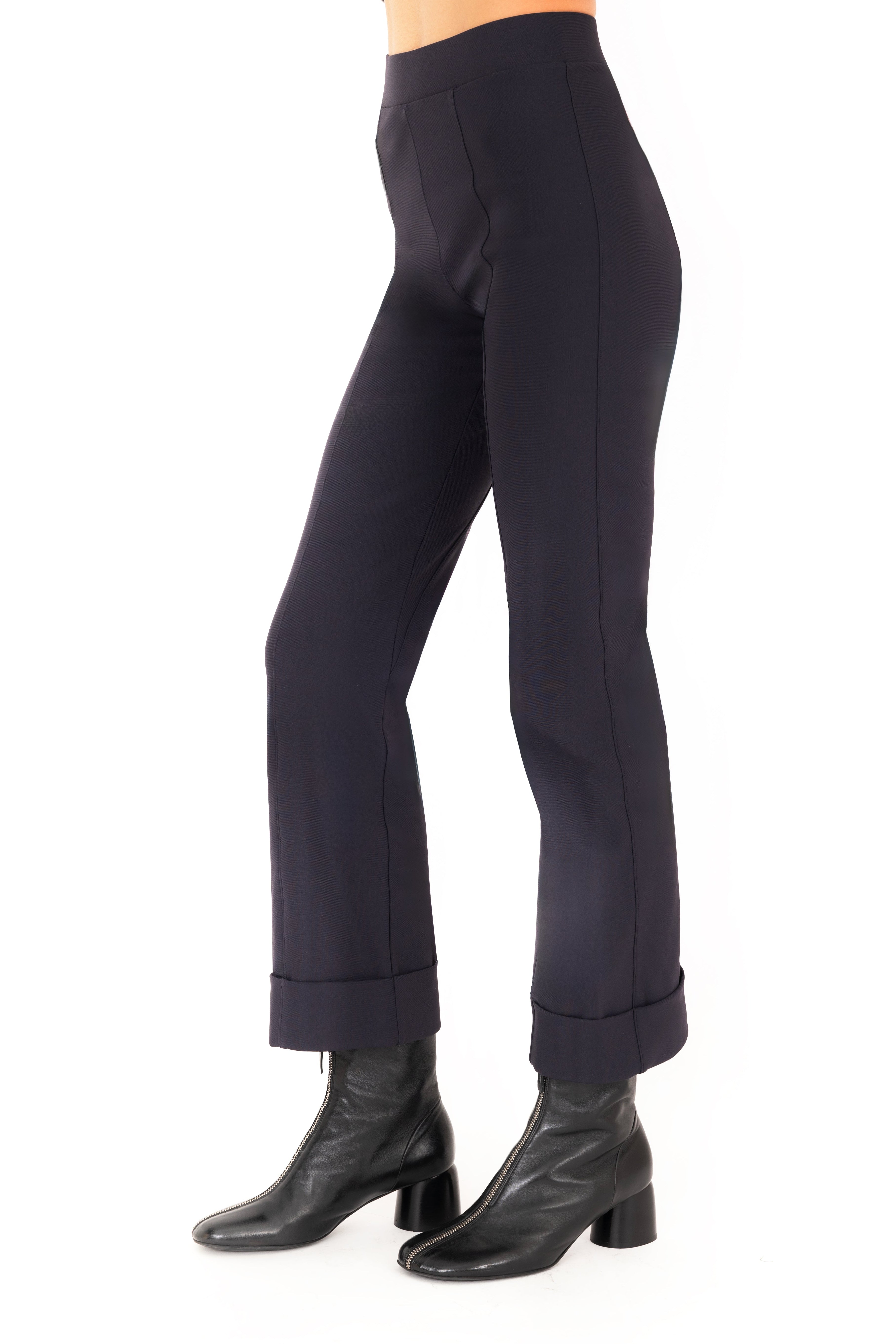 Dark blue pants worn by a person on a white background