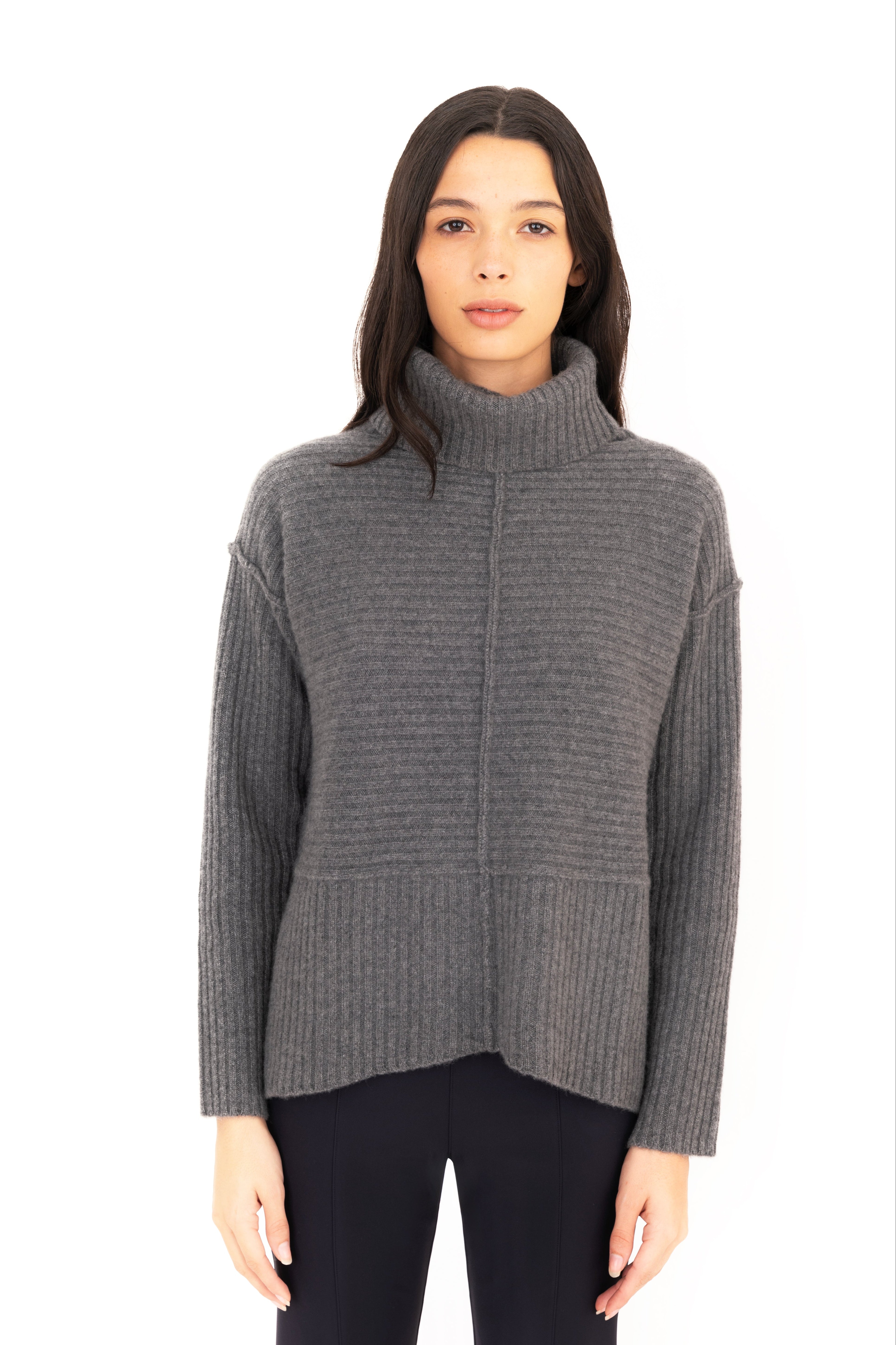 Woman wearing a gray sweater on a white background