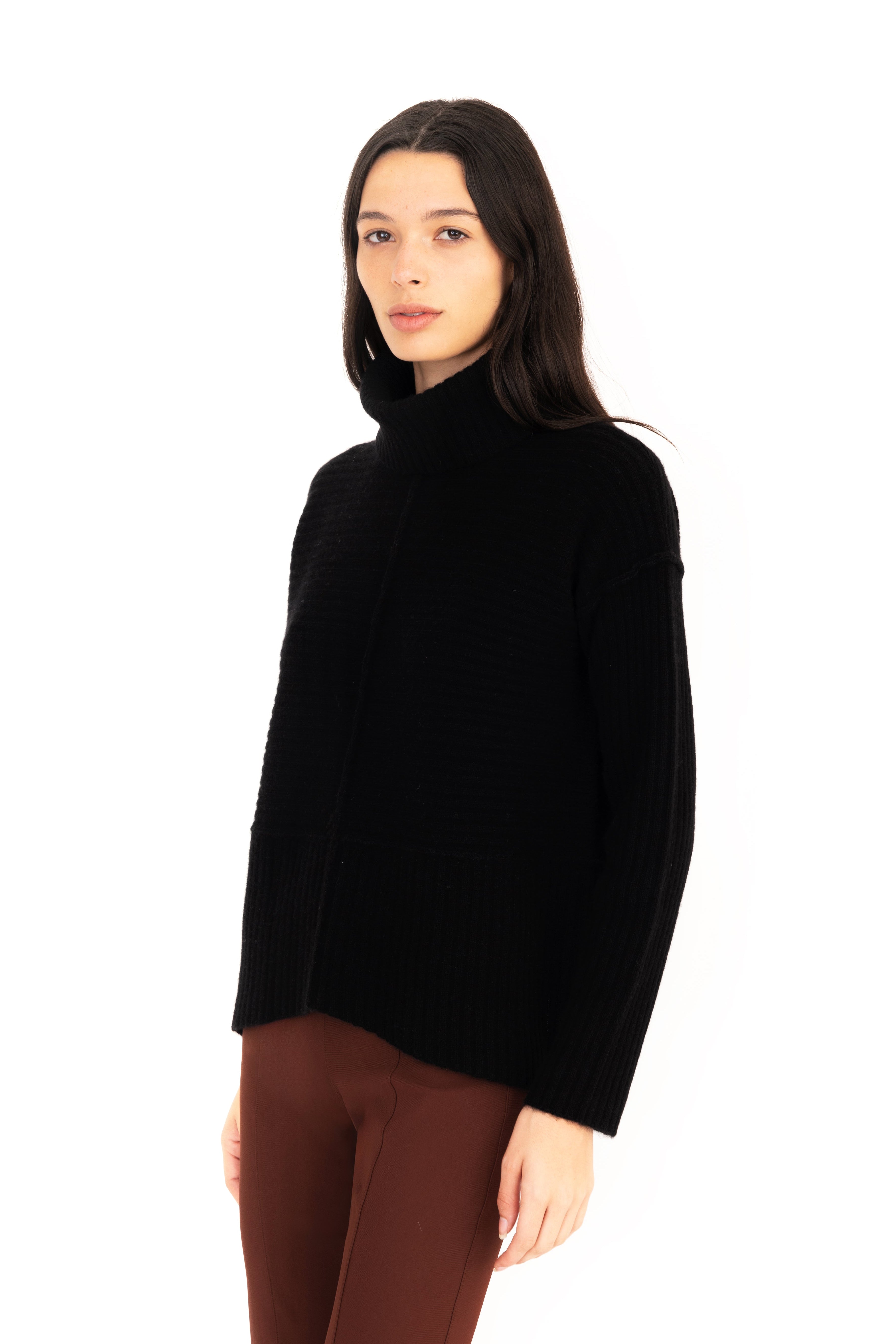 Woman wearing a black turtleneck sweater on a white background