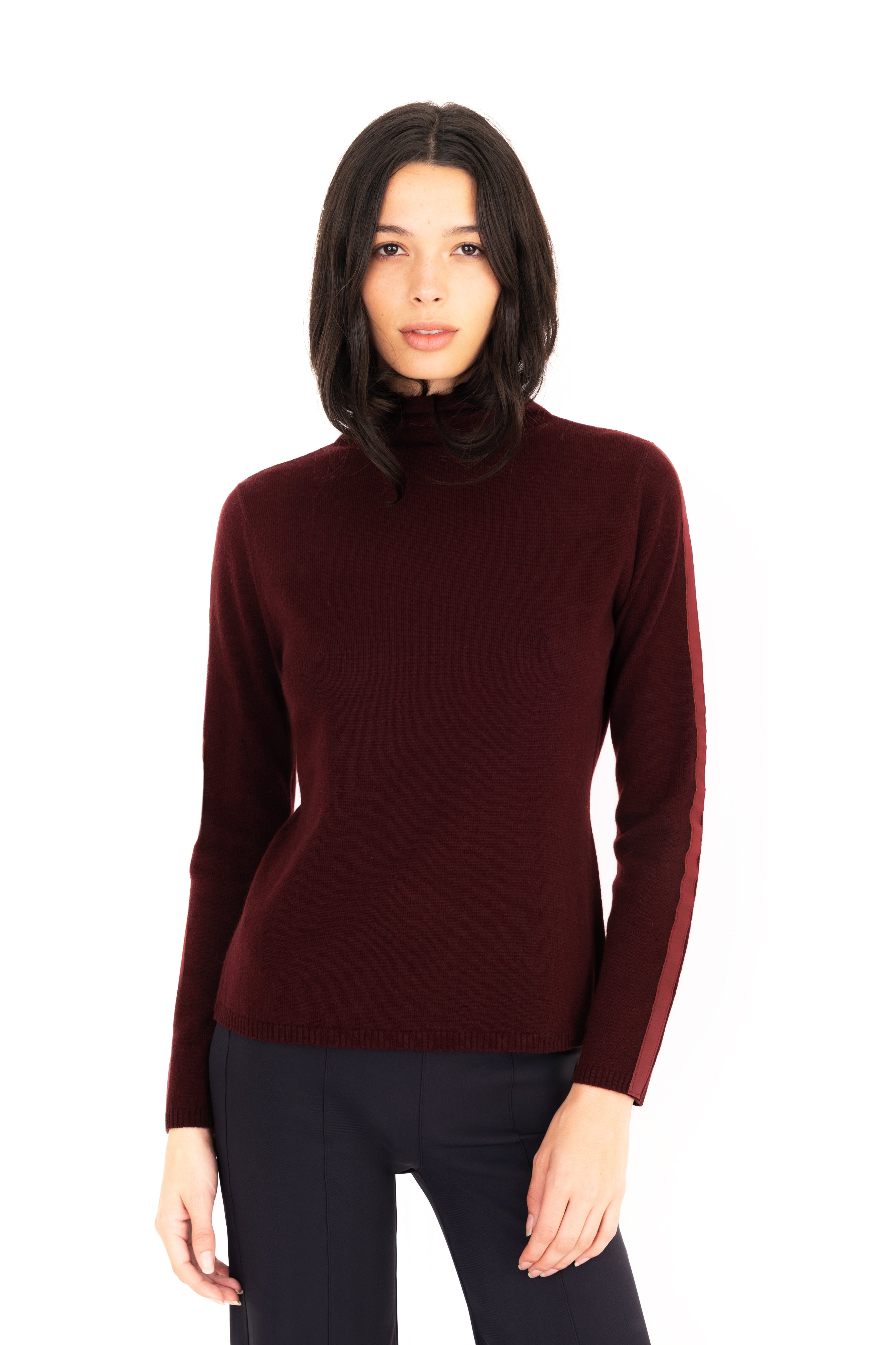 Woman wearing a burgundy turtleneck sweater on a white background