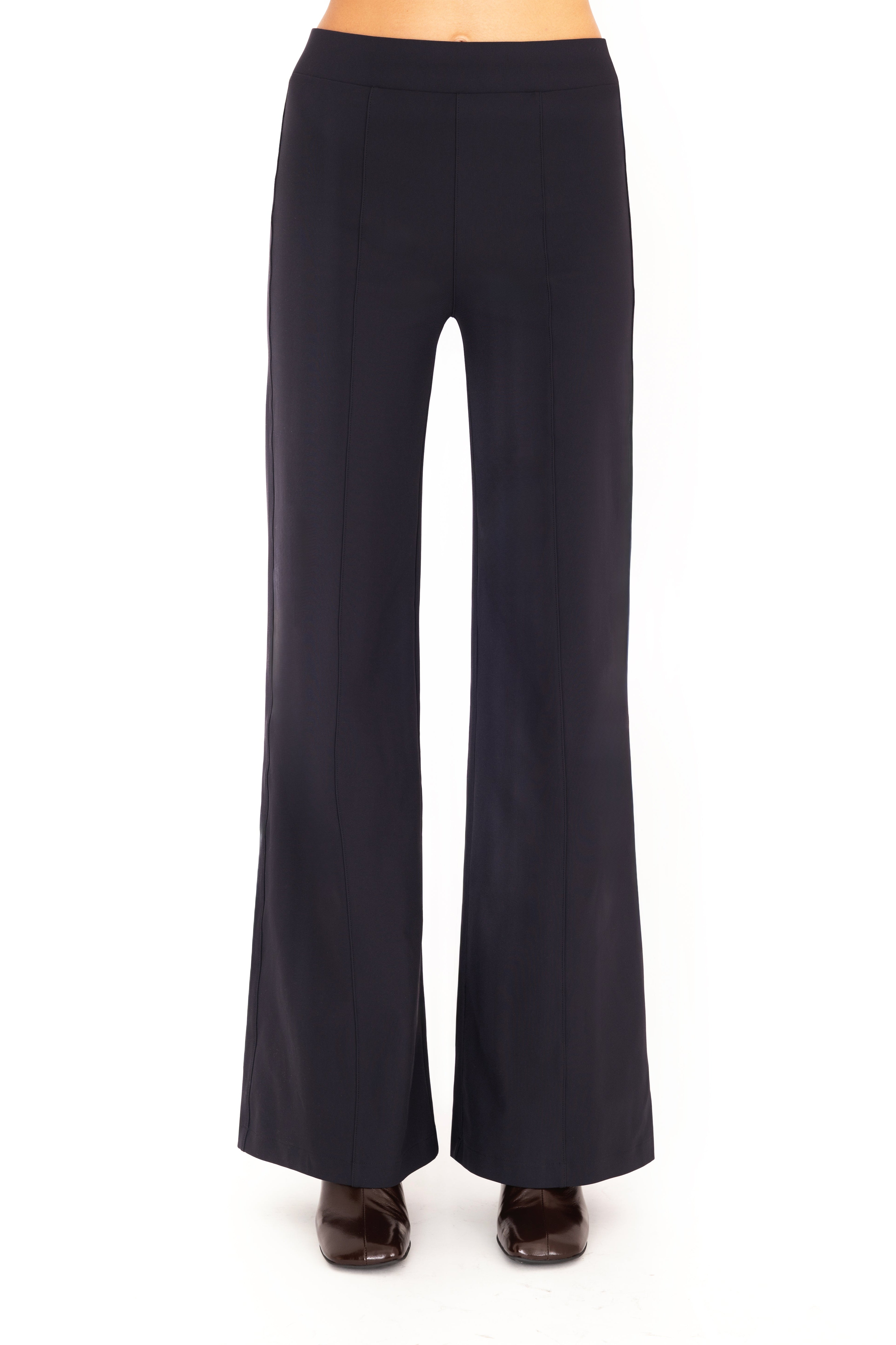 Dark blue pants worn by a person on a white background