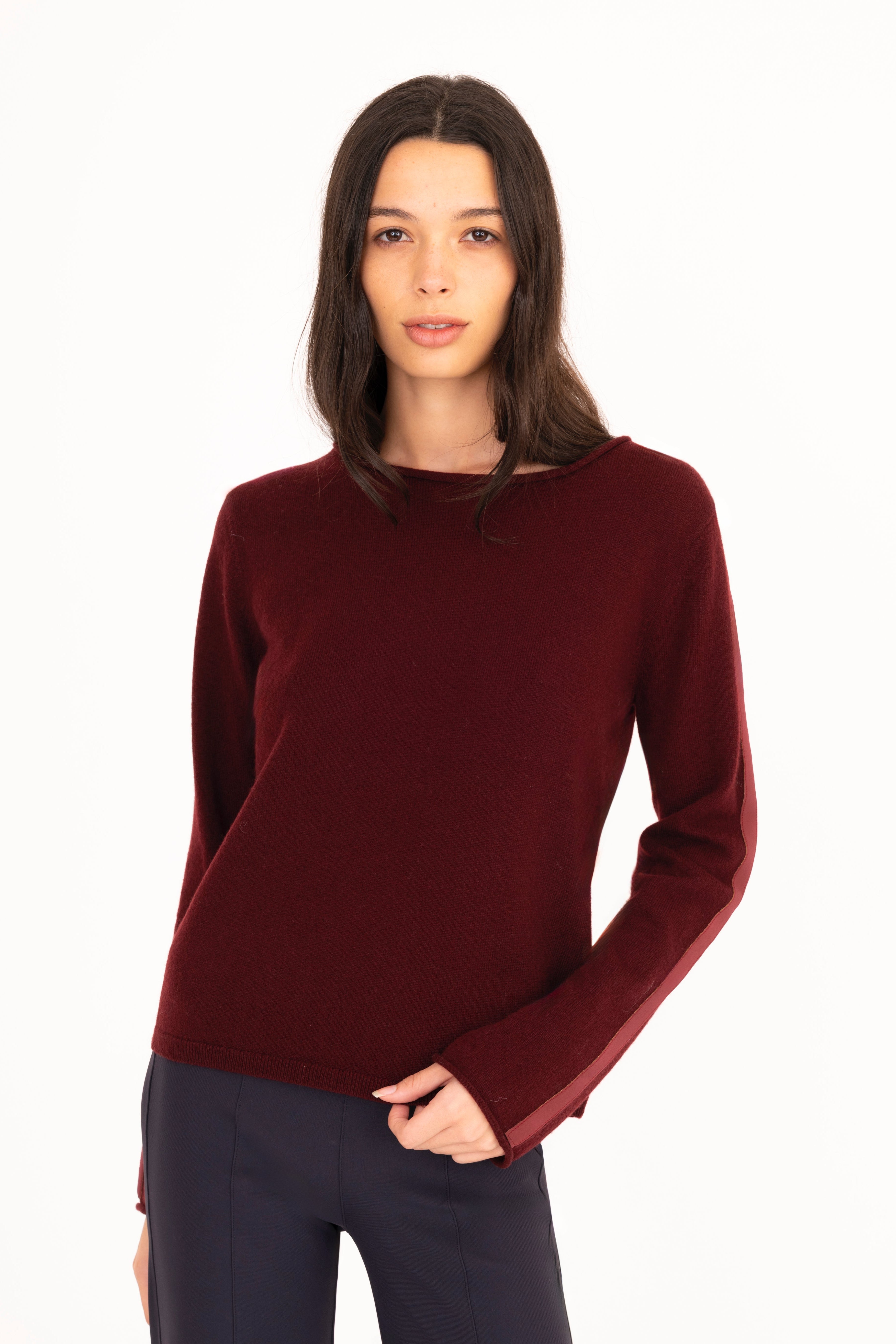 Woman wearing a burgundy sweater on a white background