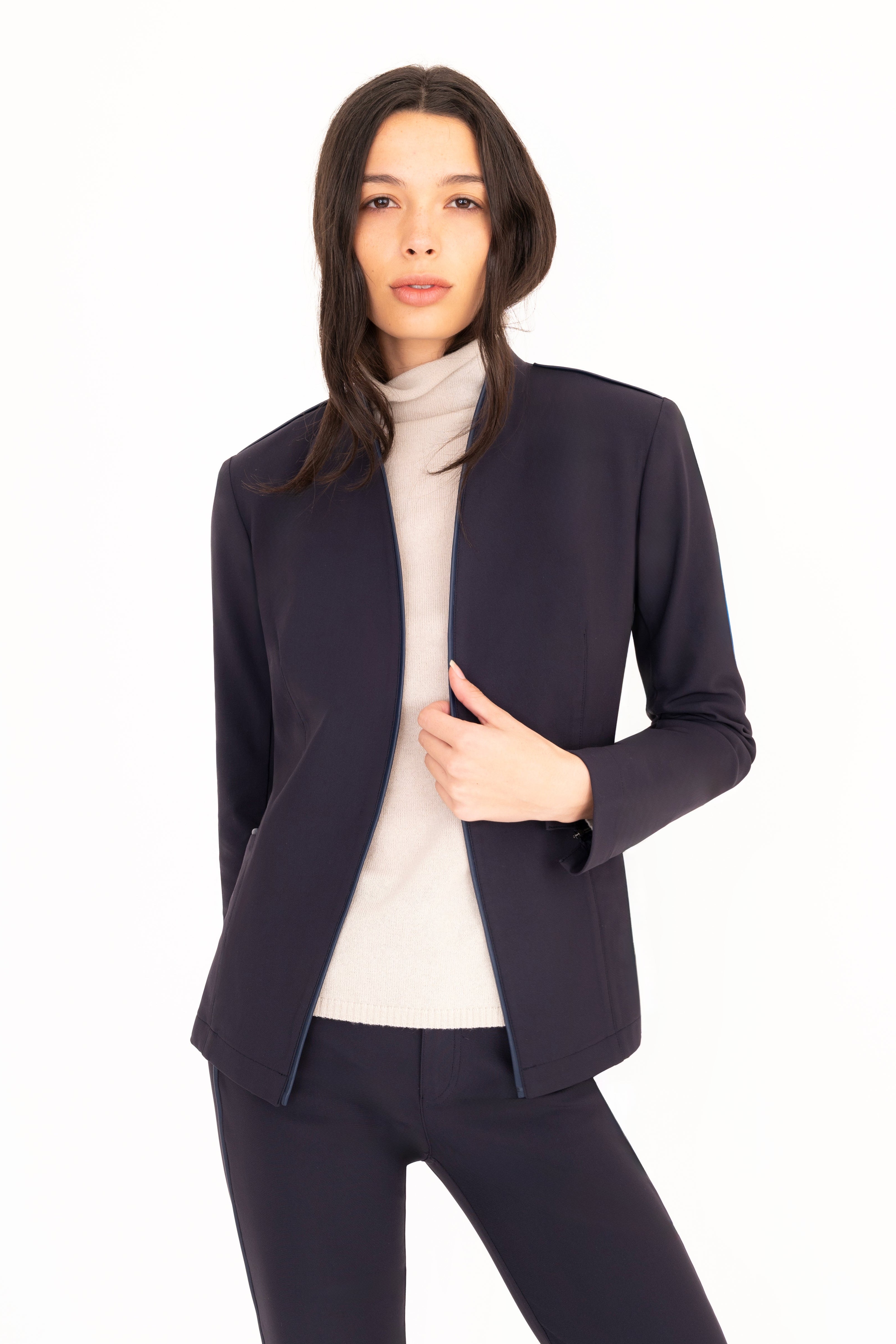 Woman wearing a navy suit with a white background