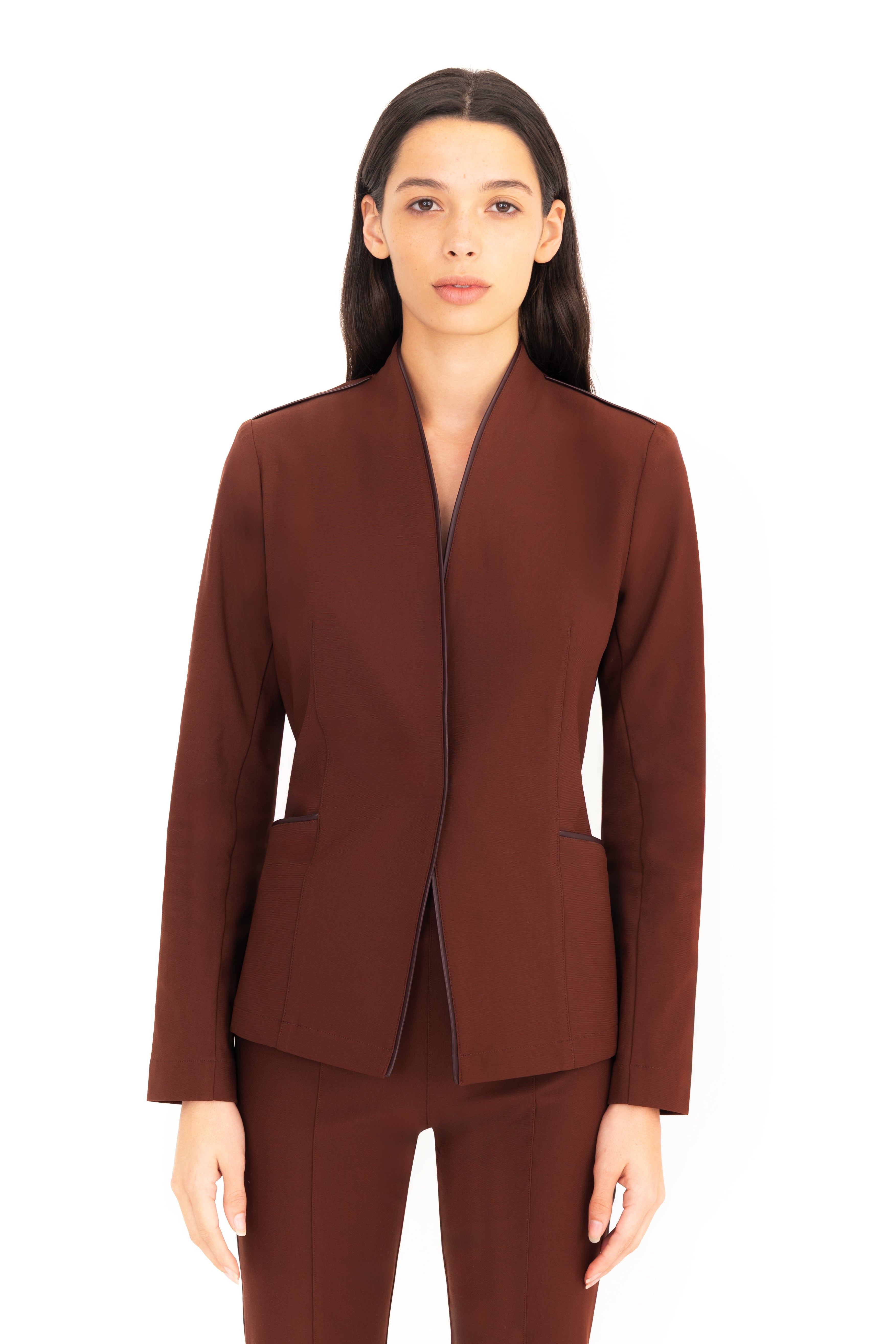 Woman wearing a brown suit on a white background