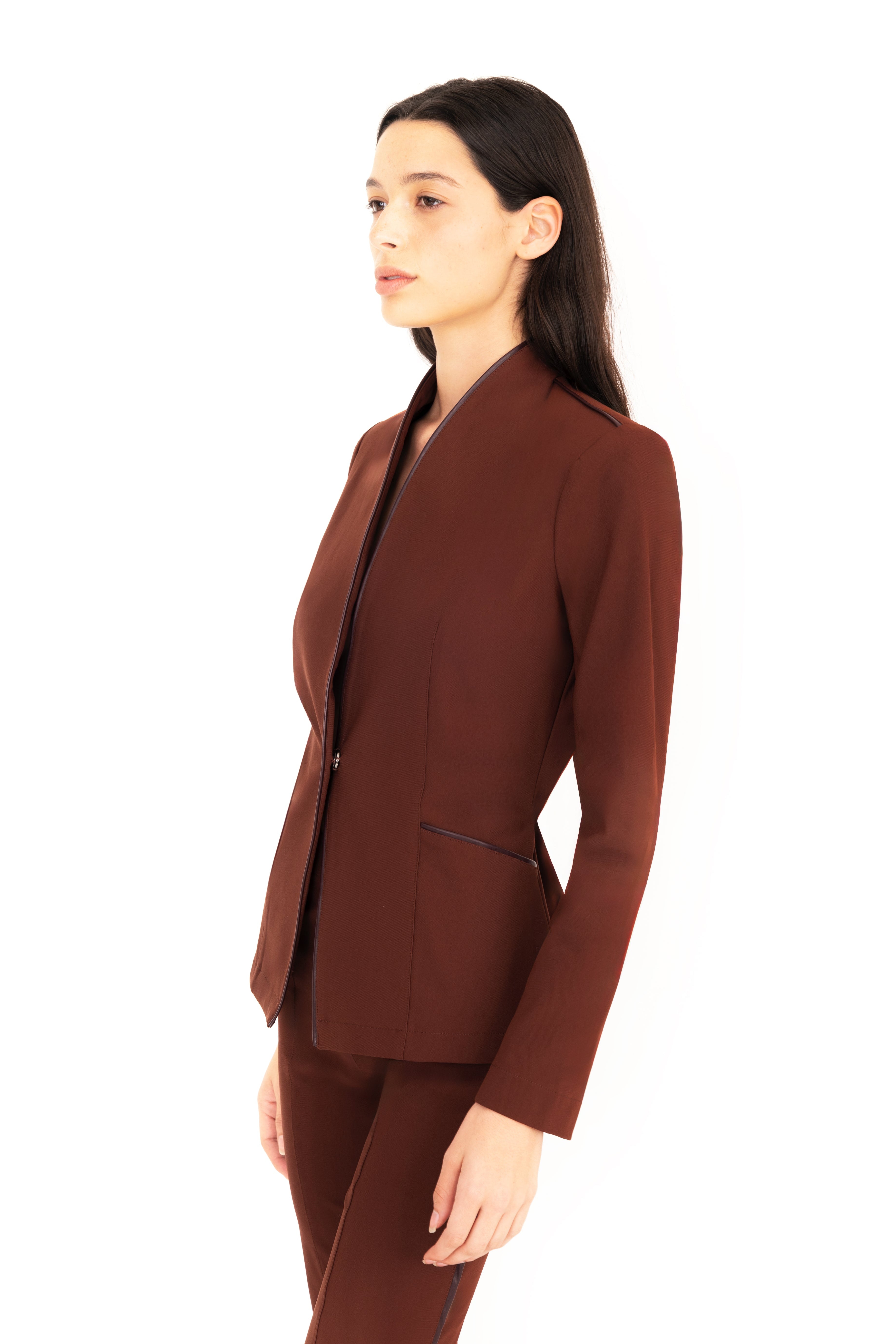 Woman wearing a brown suit on a white background