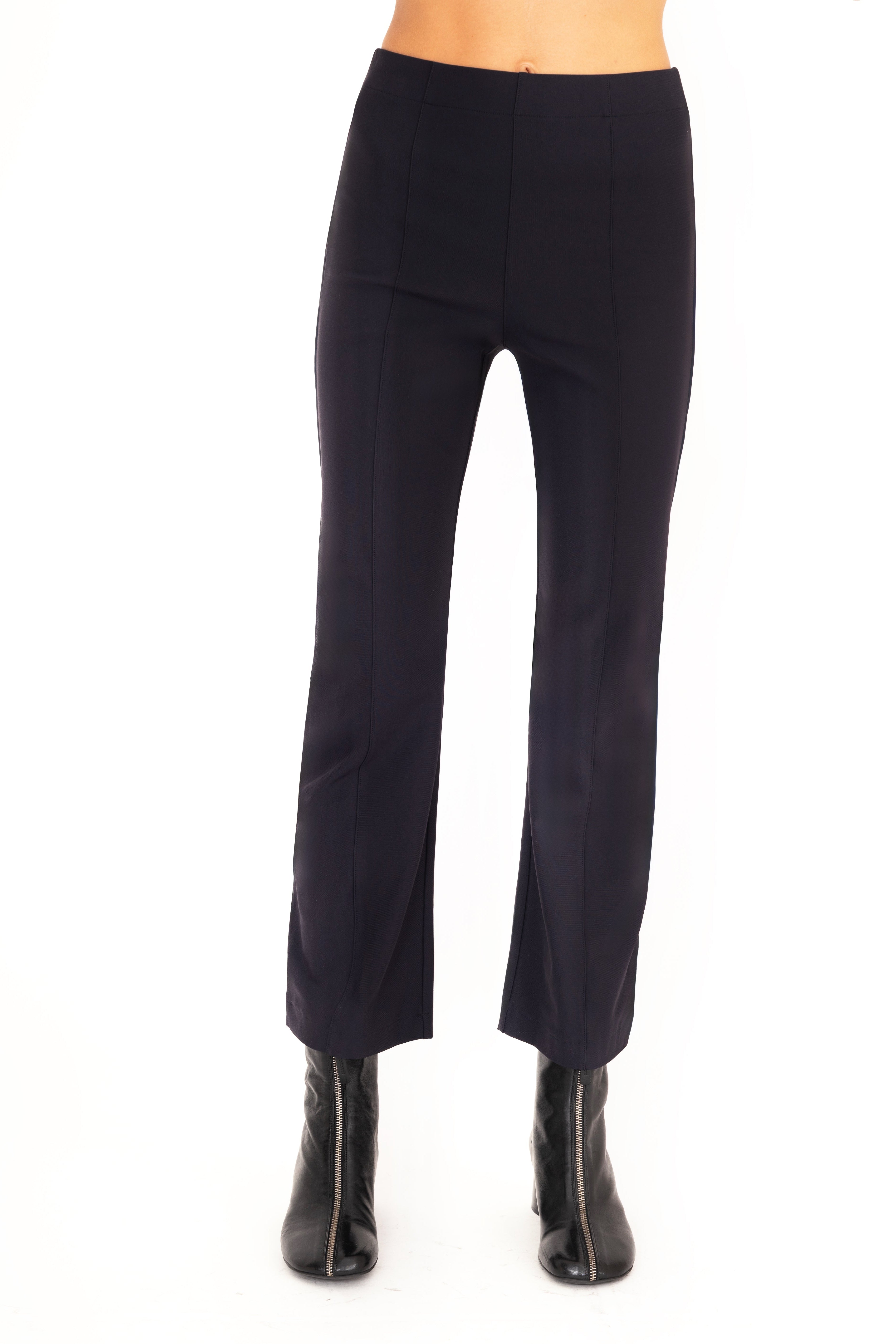 Dark blue pants worn by a person on a white background