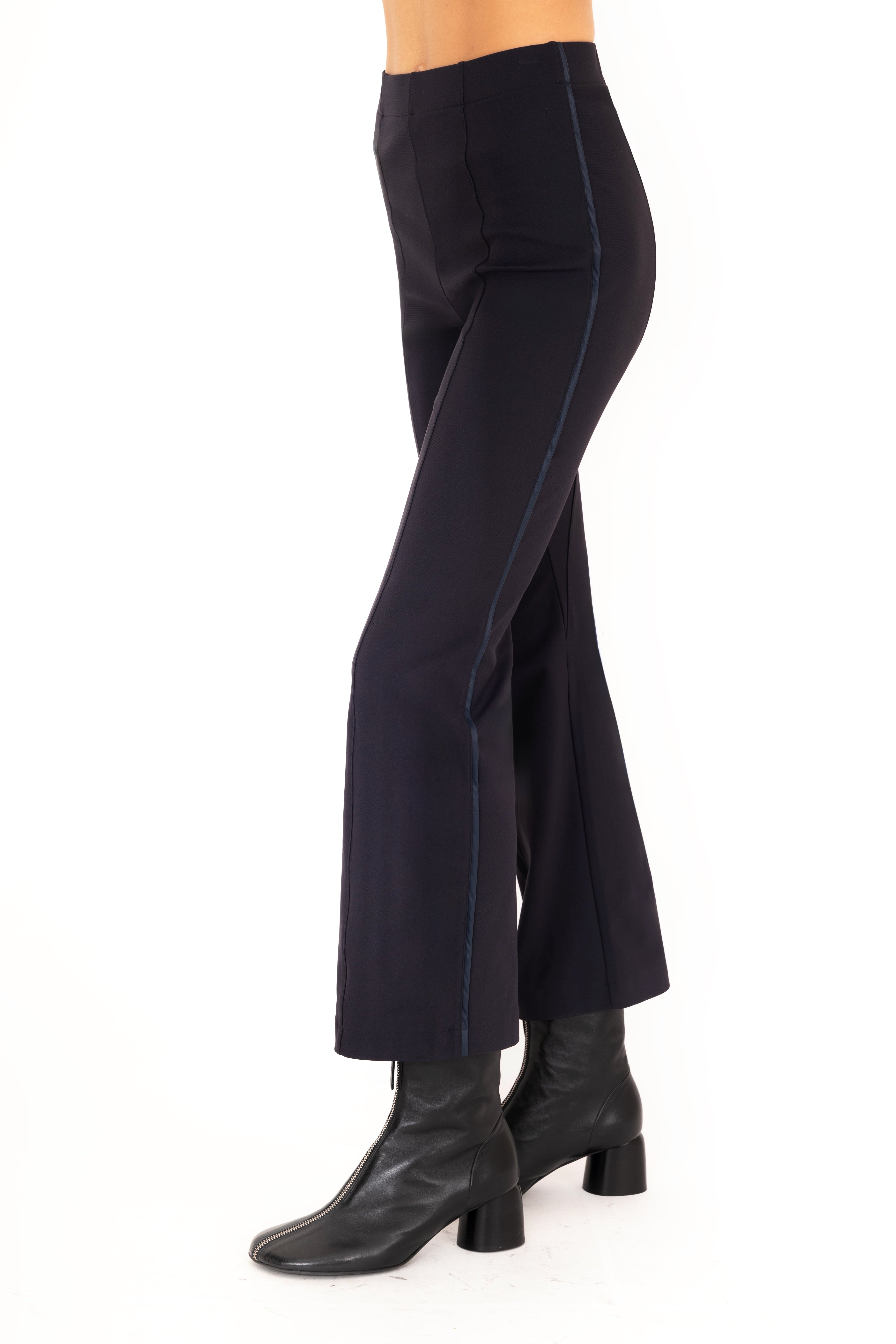 Dark blue pants worn by a person on a white background