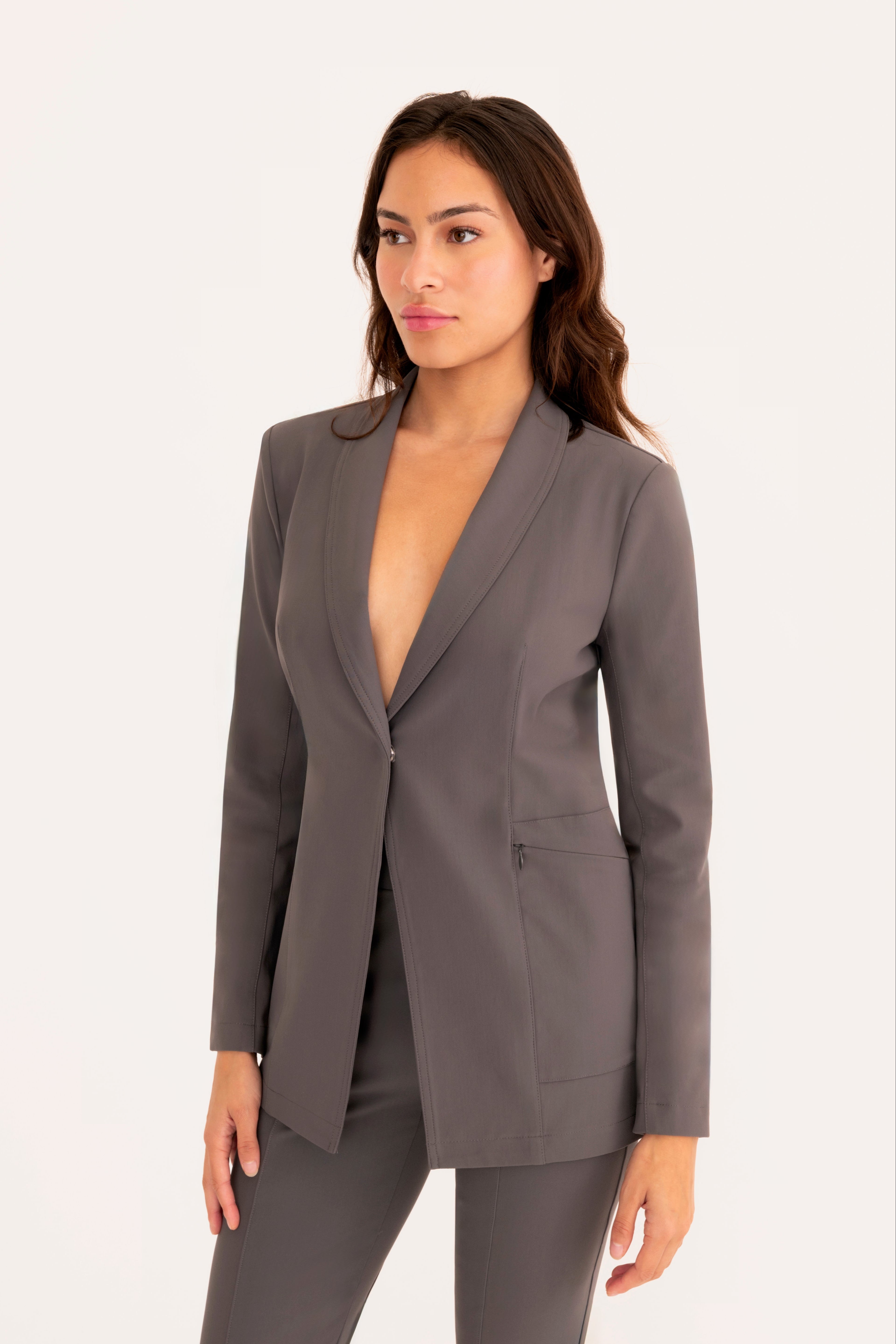 Woman wearing a gray suit on a white background