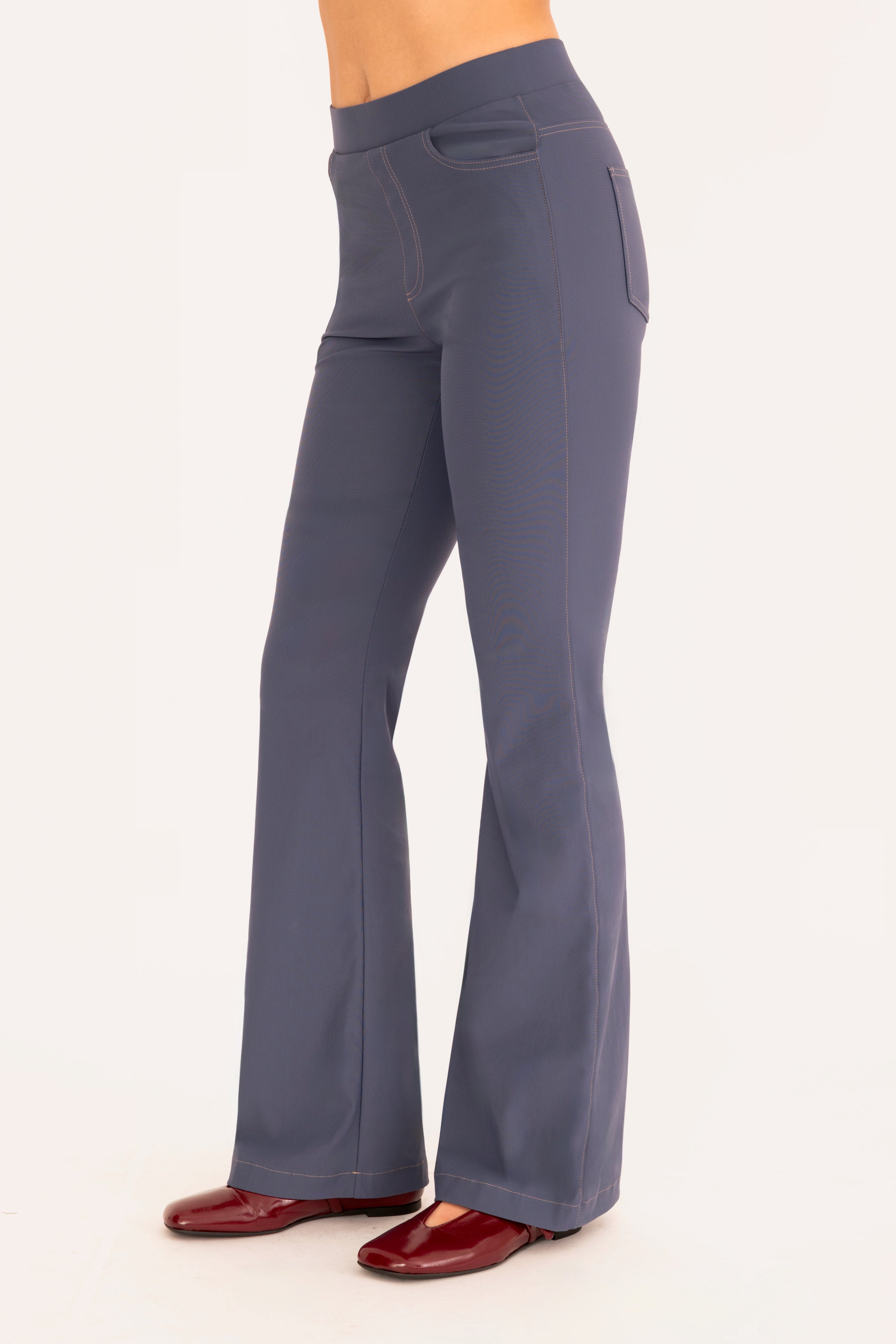 Side view of blue flare jean pants on a white background