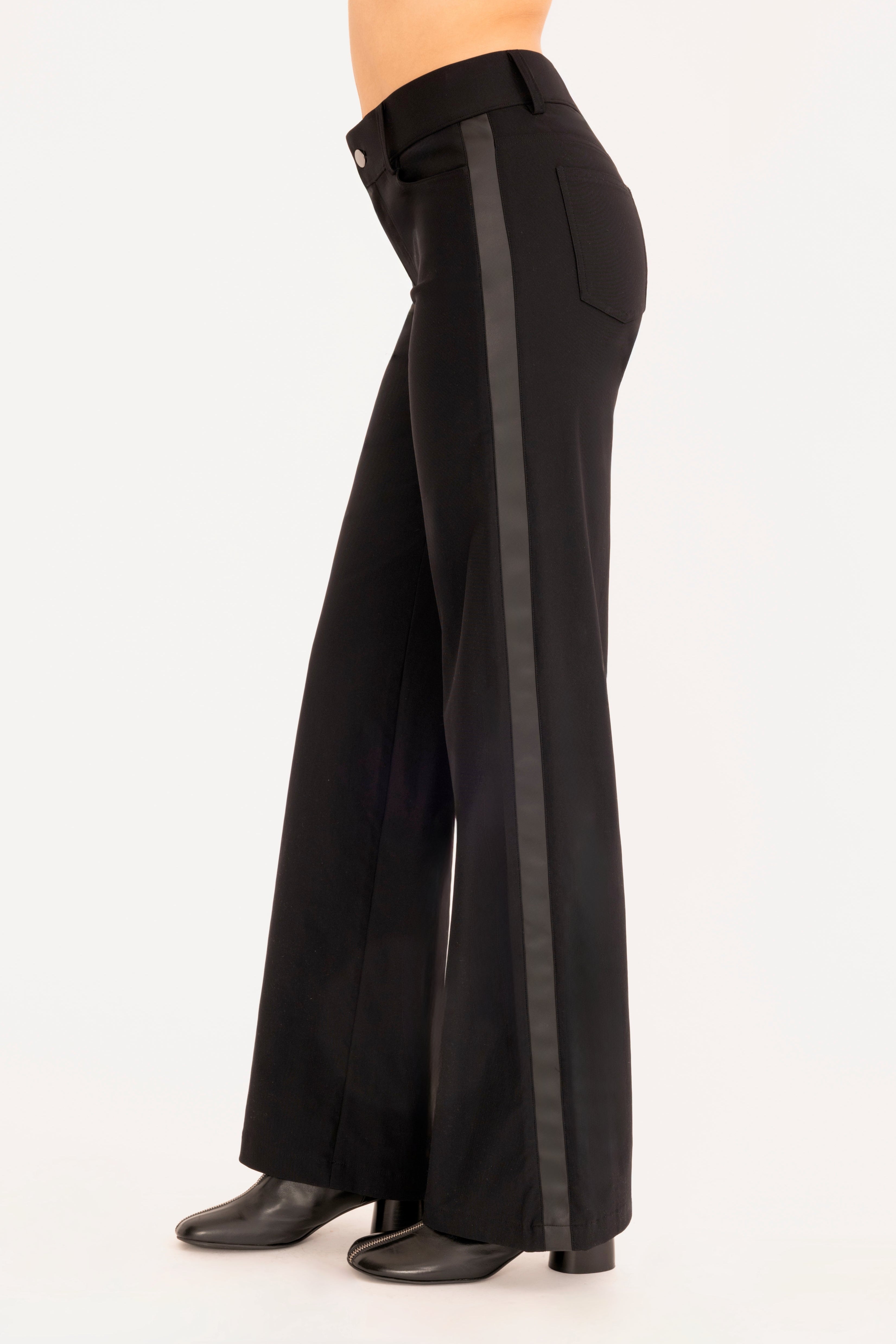 Side view of black wide leg jean pants on a white background