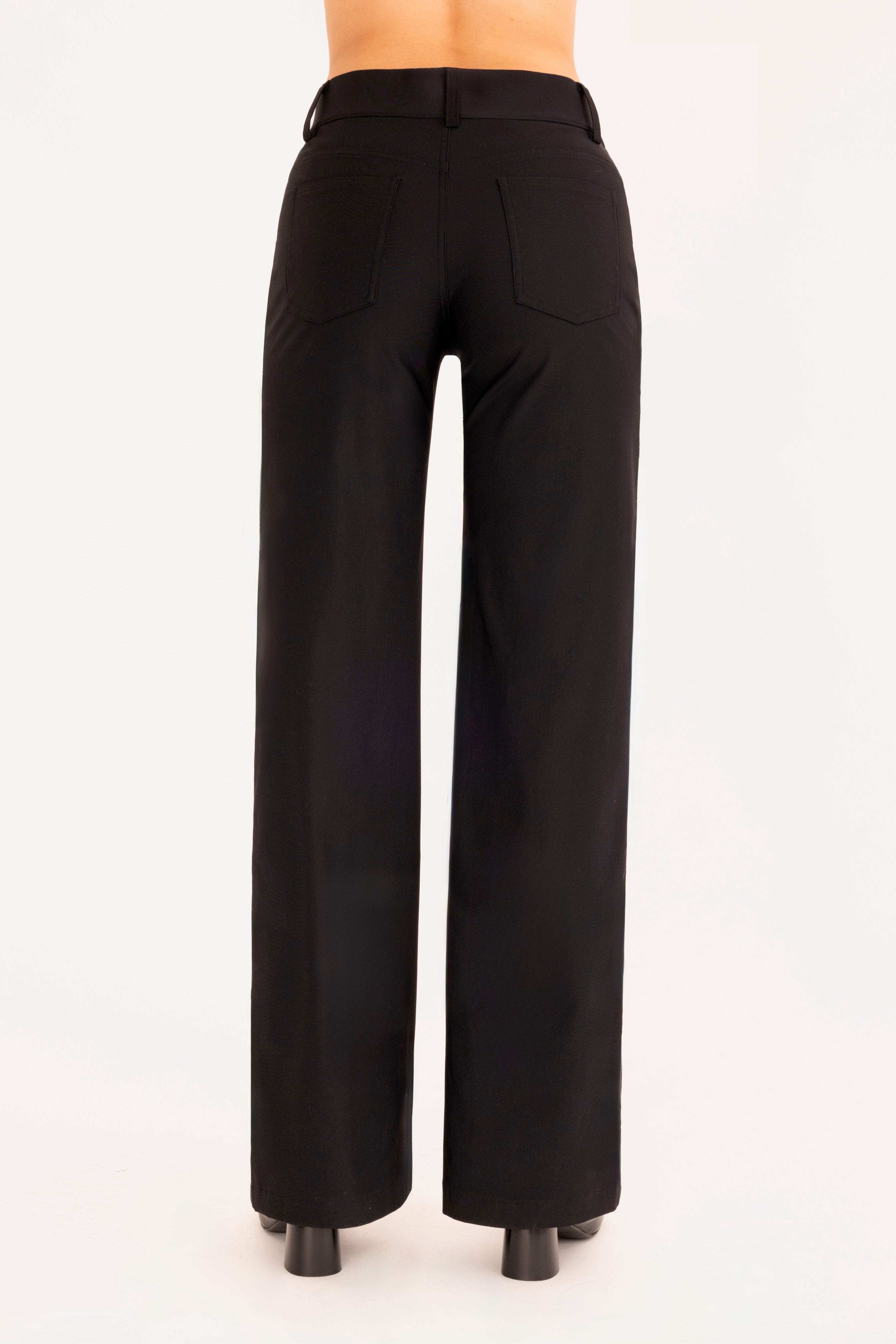 Back view of black wide leg jean pants on a white background