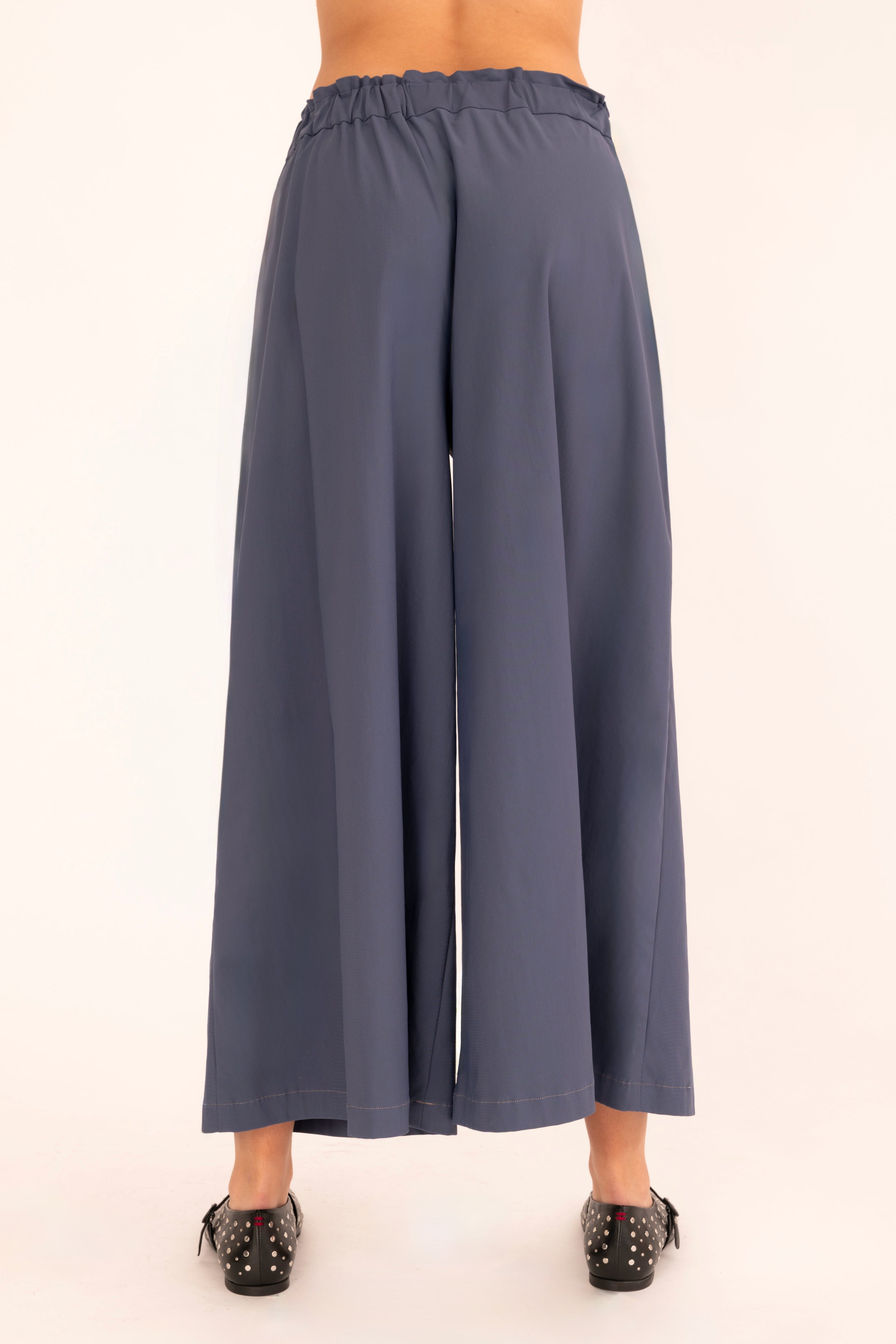 Back view of blue culotte pant on a white background