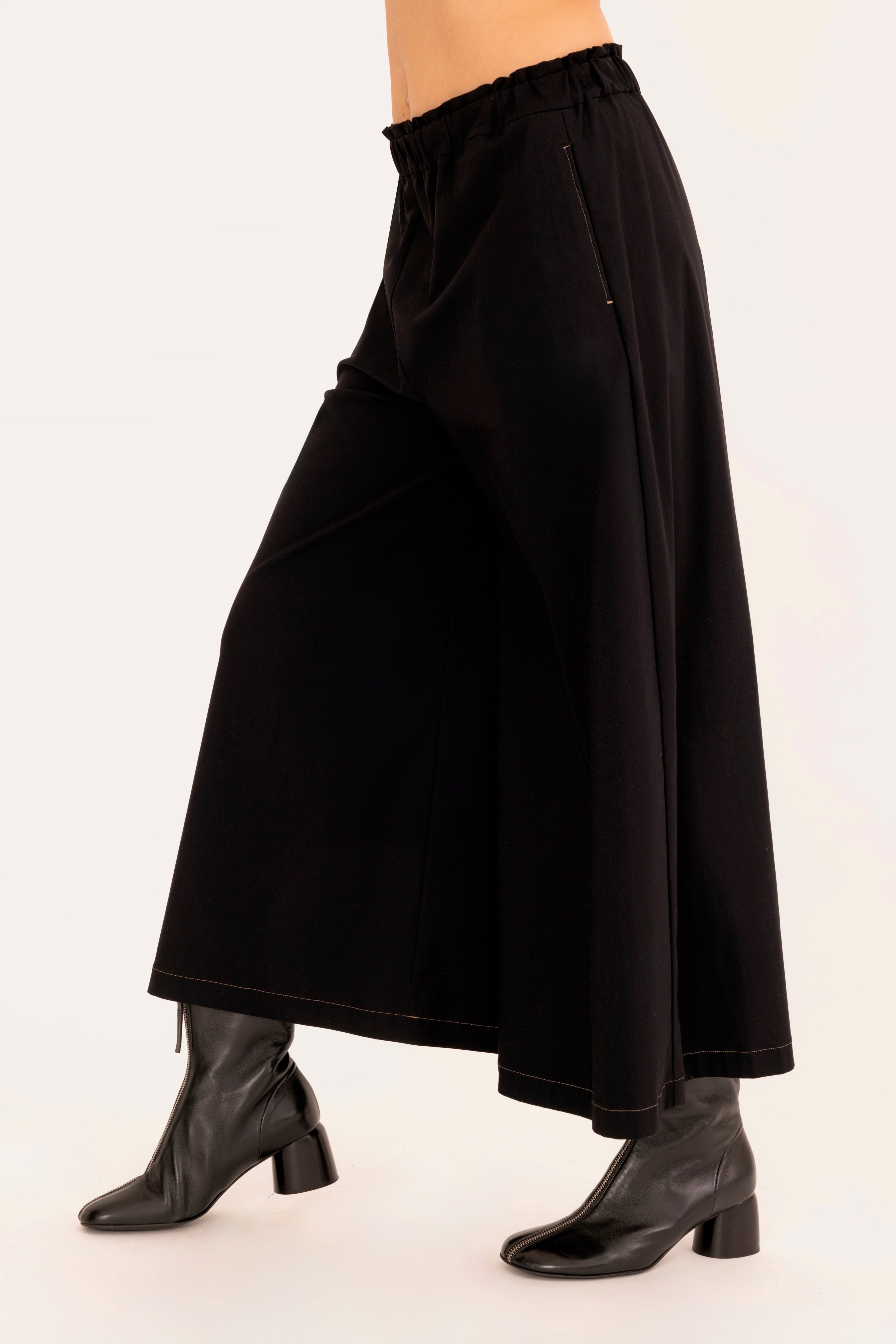 Side view of black culotte pant on a white background