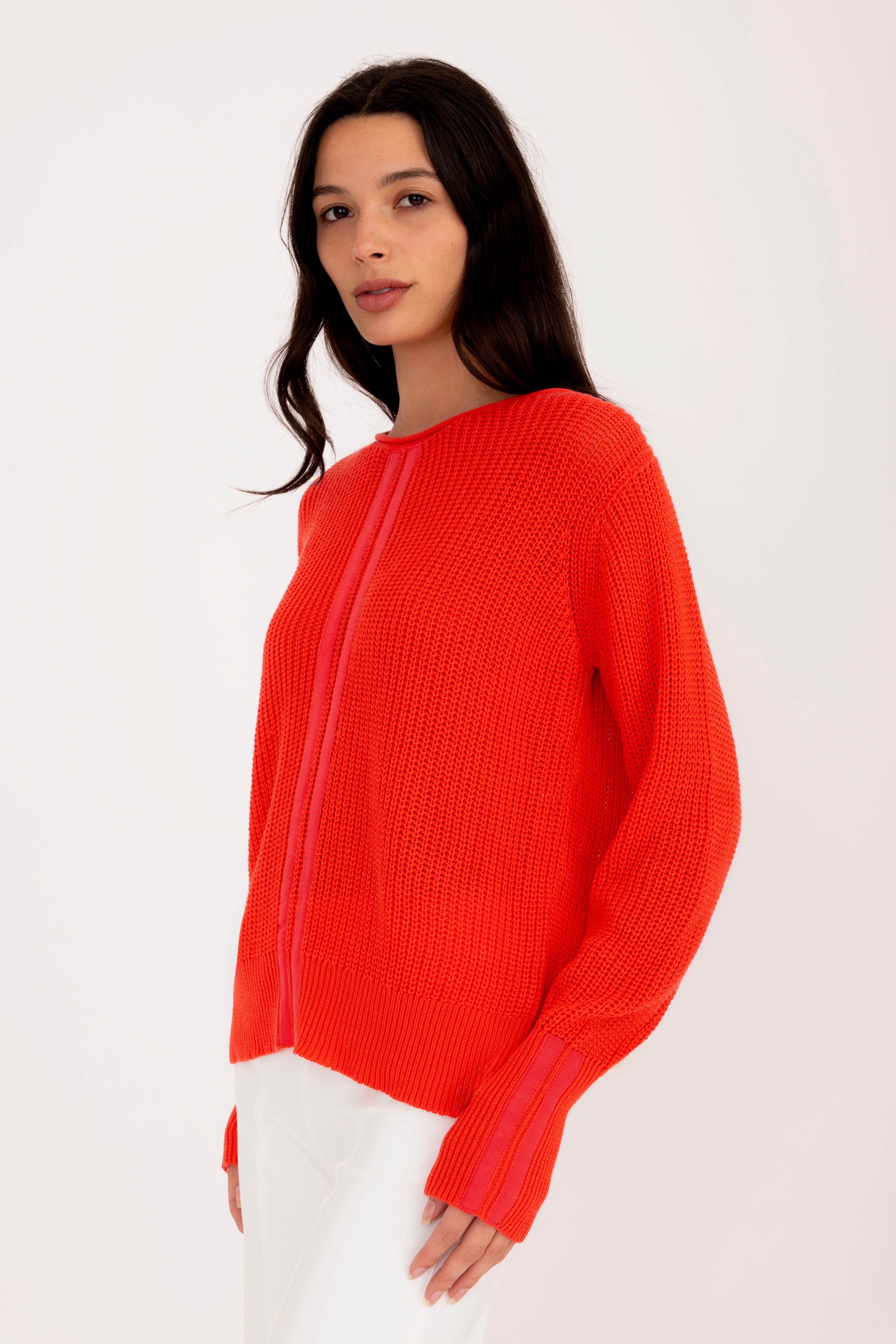 Woman wearing a orange sweater on a white background