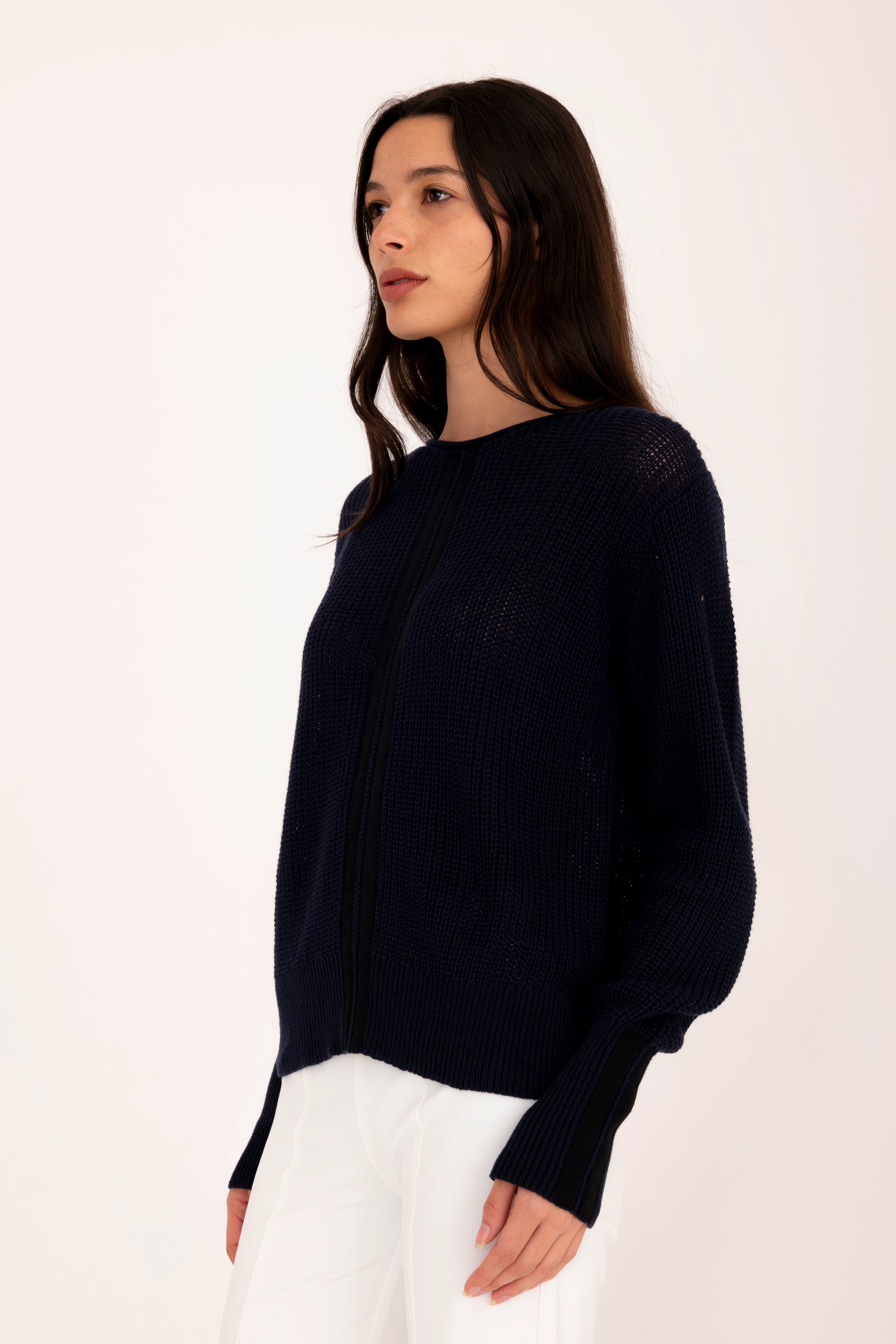 Woman wearing a pink sweater on a white background