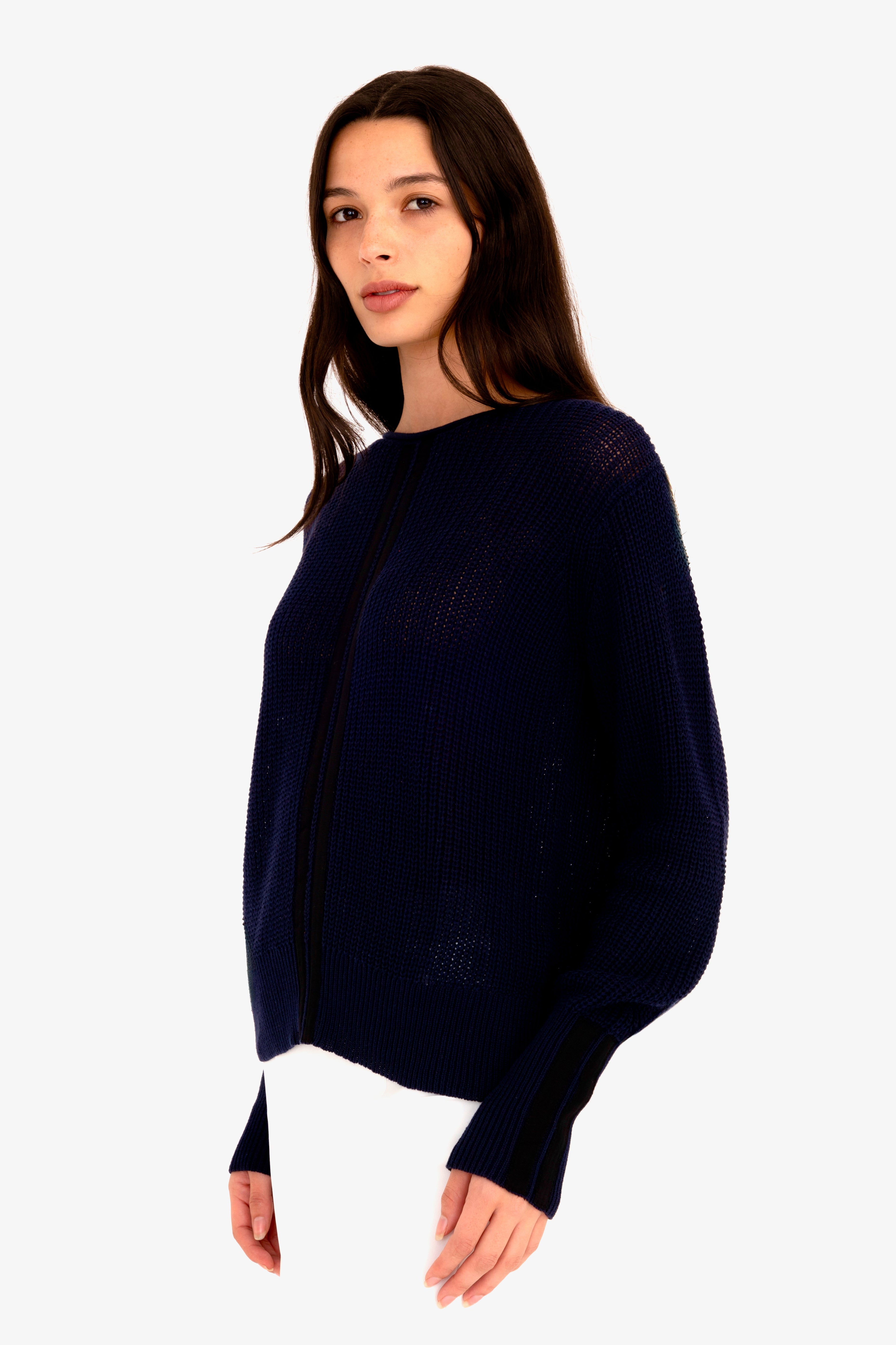 Woman wearing a dark blue sweater on a white background