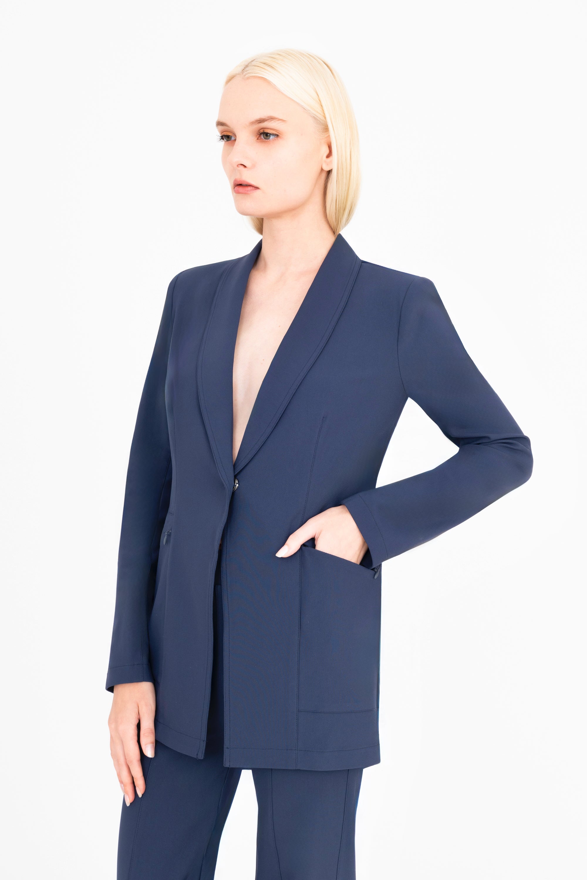 Woman wearing a navy blue suit on a white background
