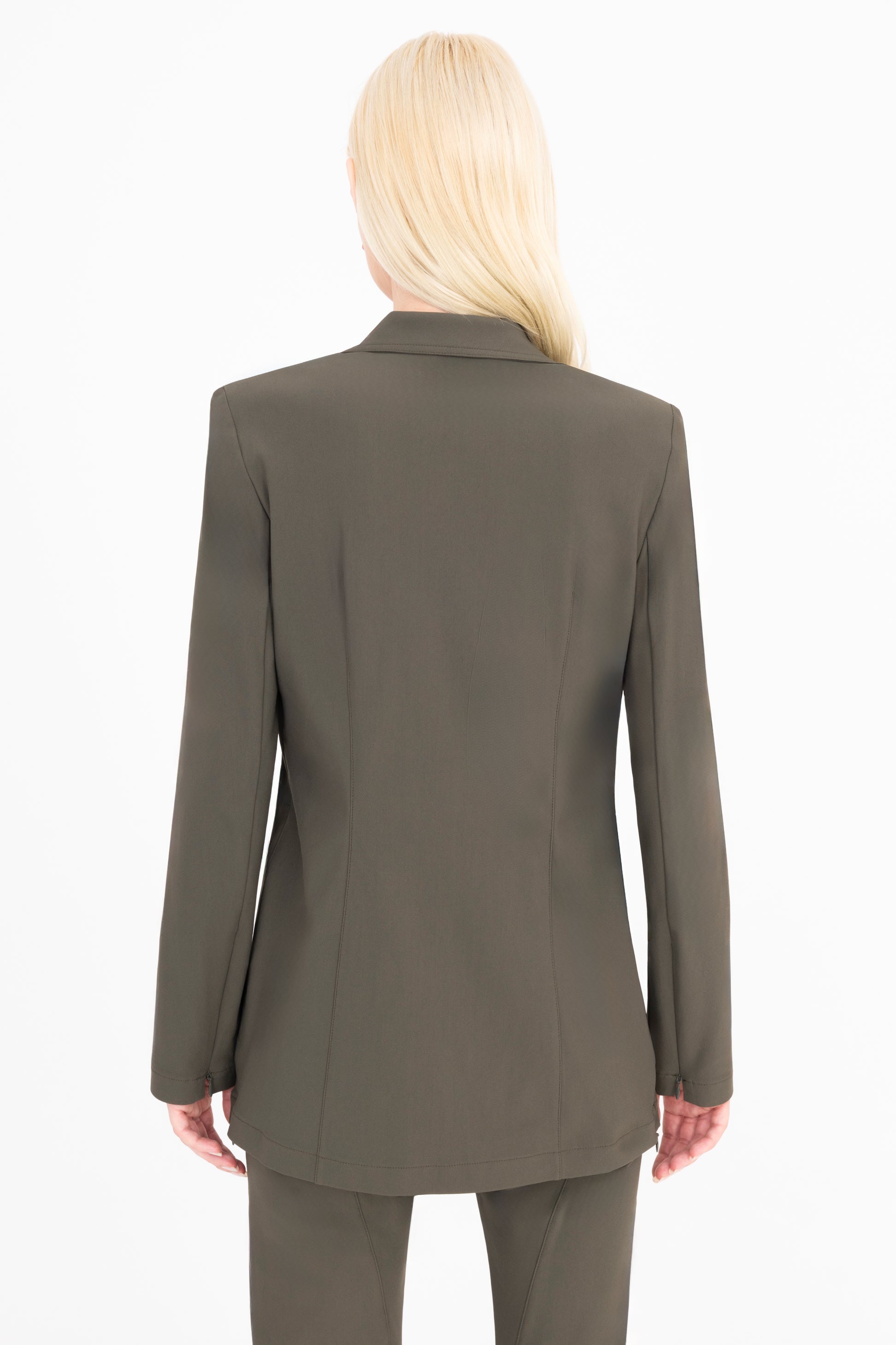 Woman wearing a green suit on a white background