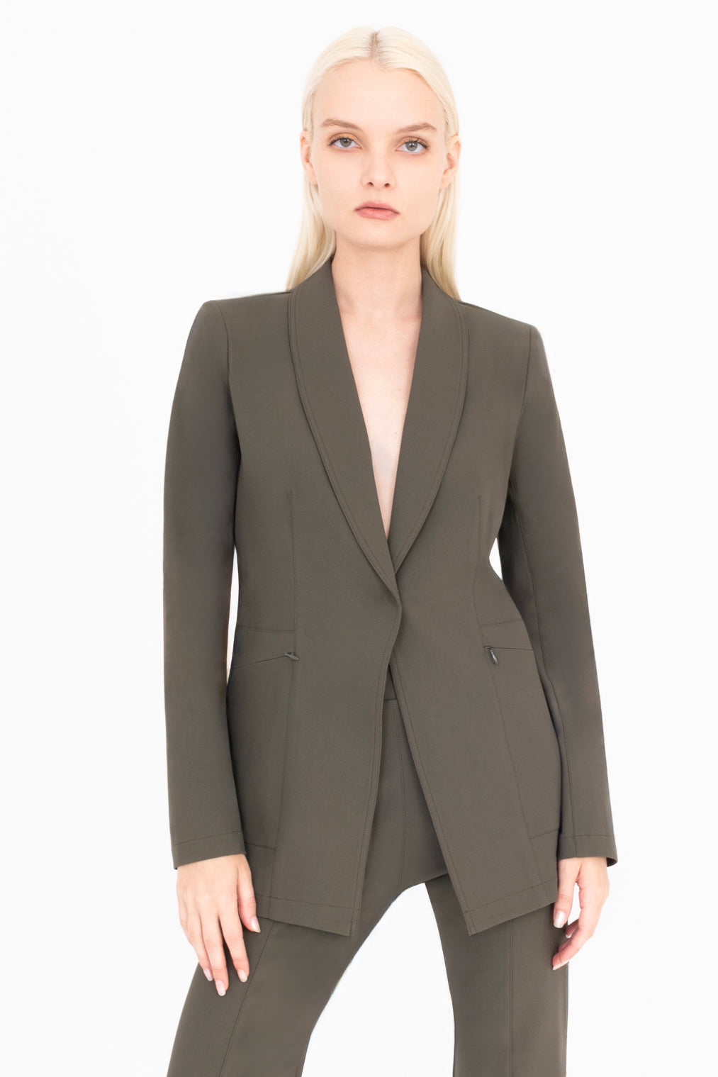 Woman wearing a green suit on a white background