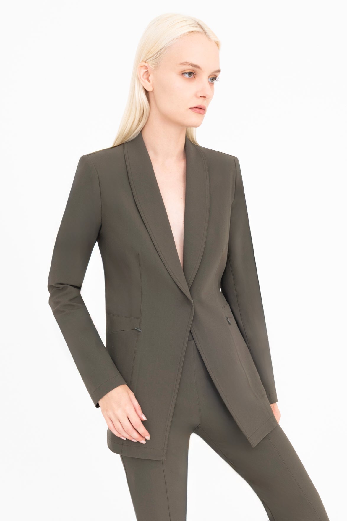 Woman wearing a green suit on a white background