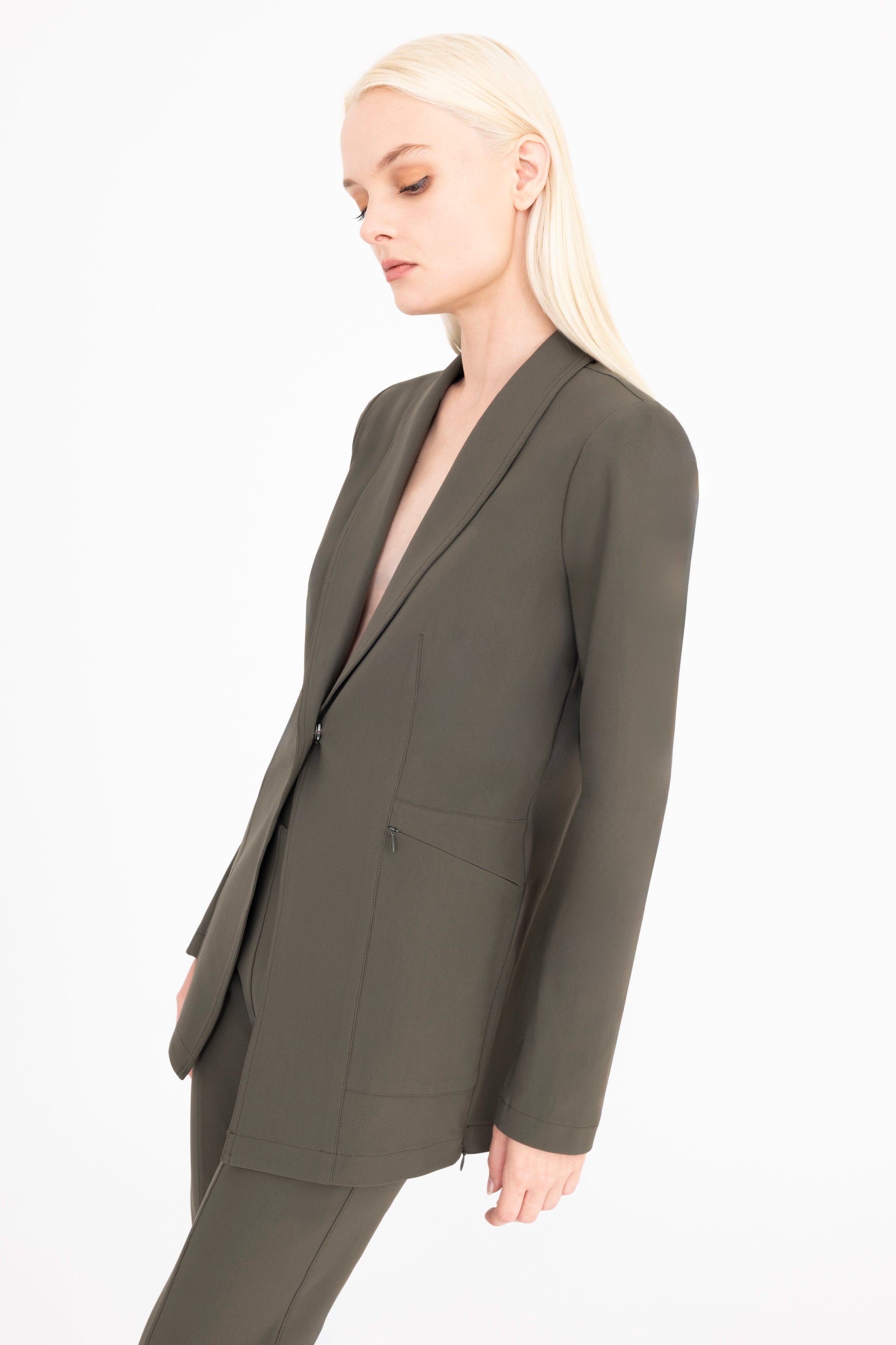 Woman wearing a green suit on a white background