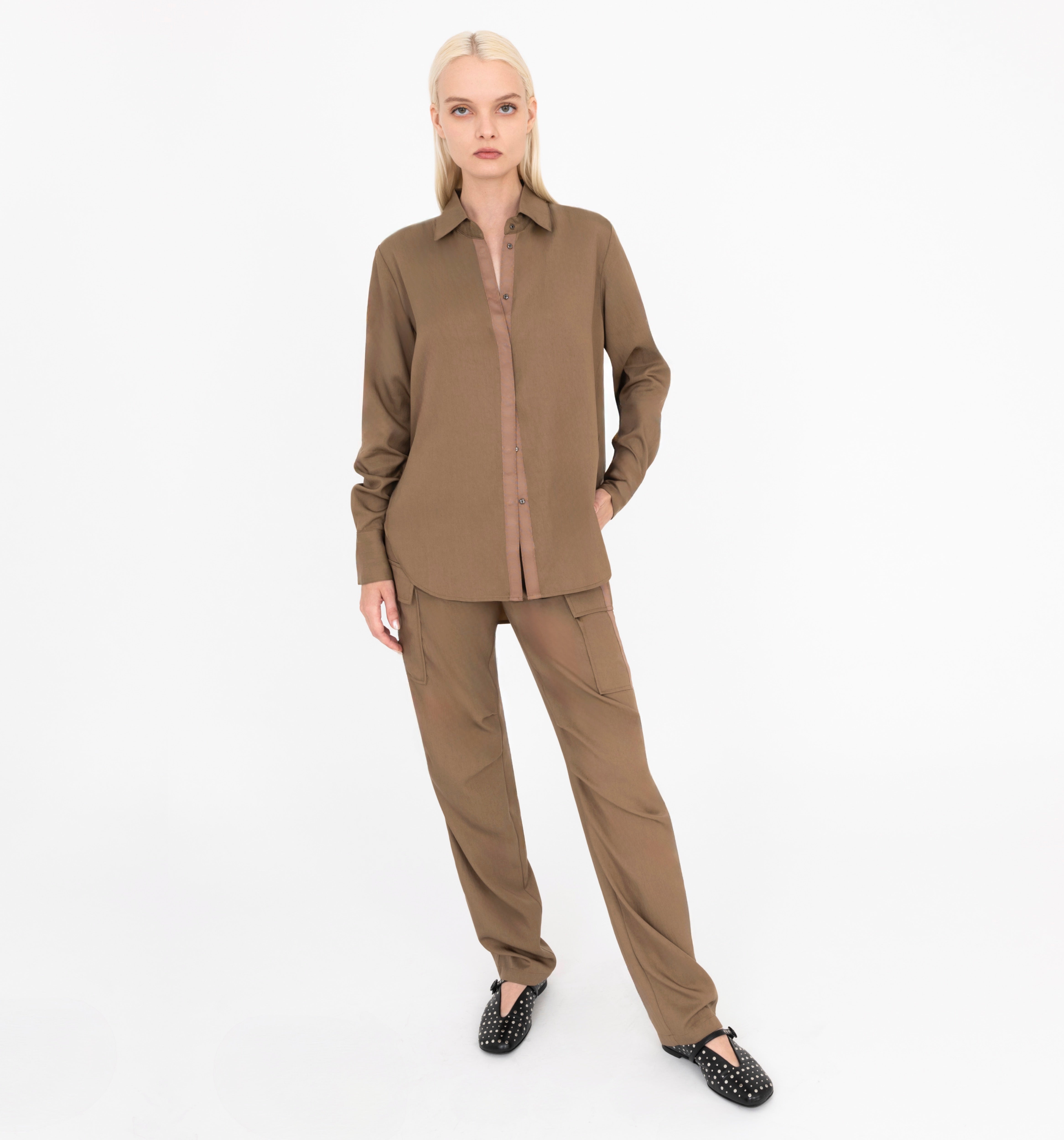 Woman wearing a brown outfit on a white background