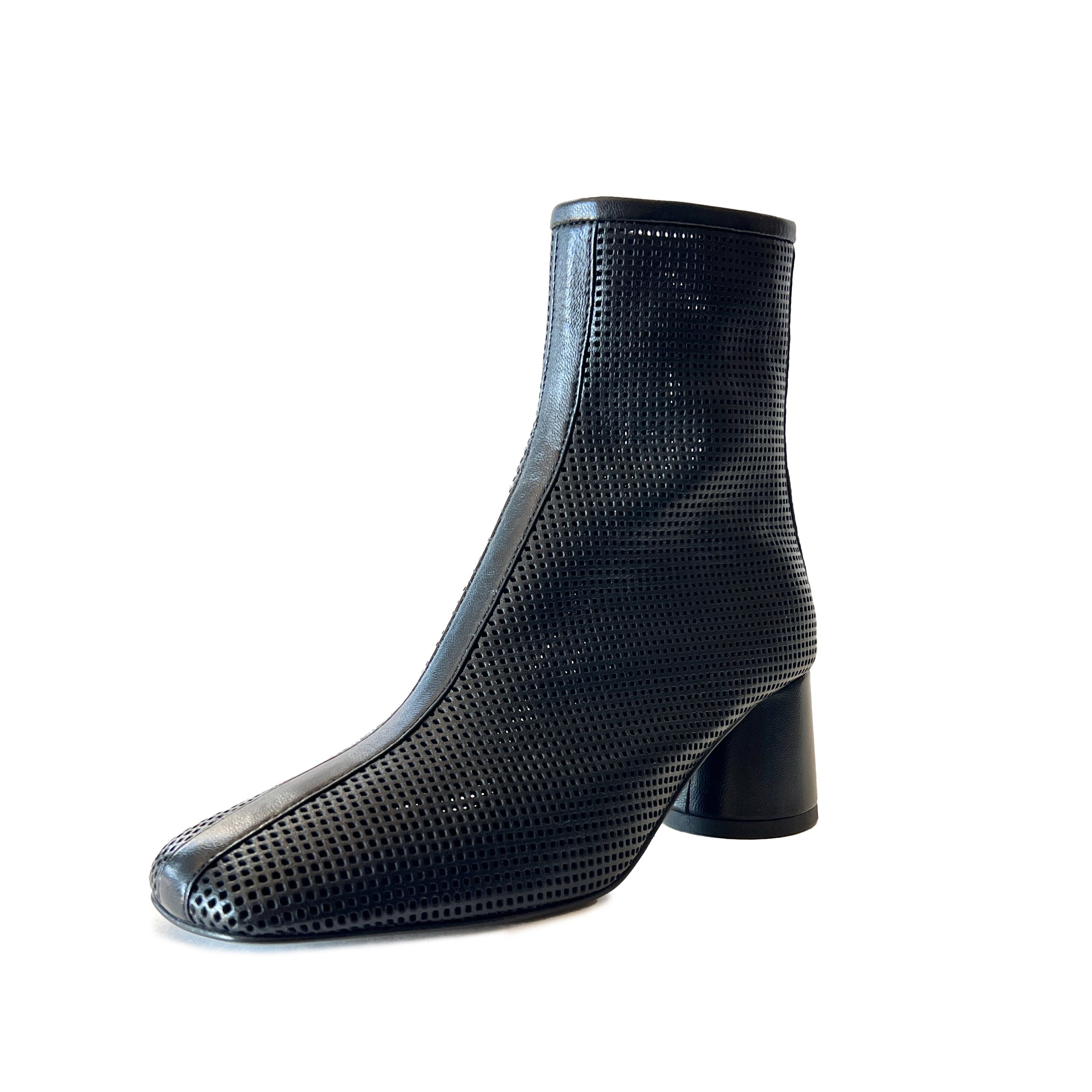 Black round toe perforated ankle boot on a white background
