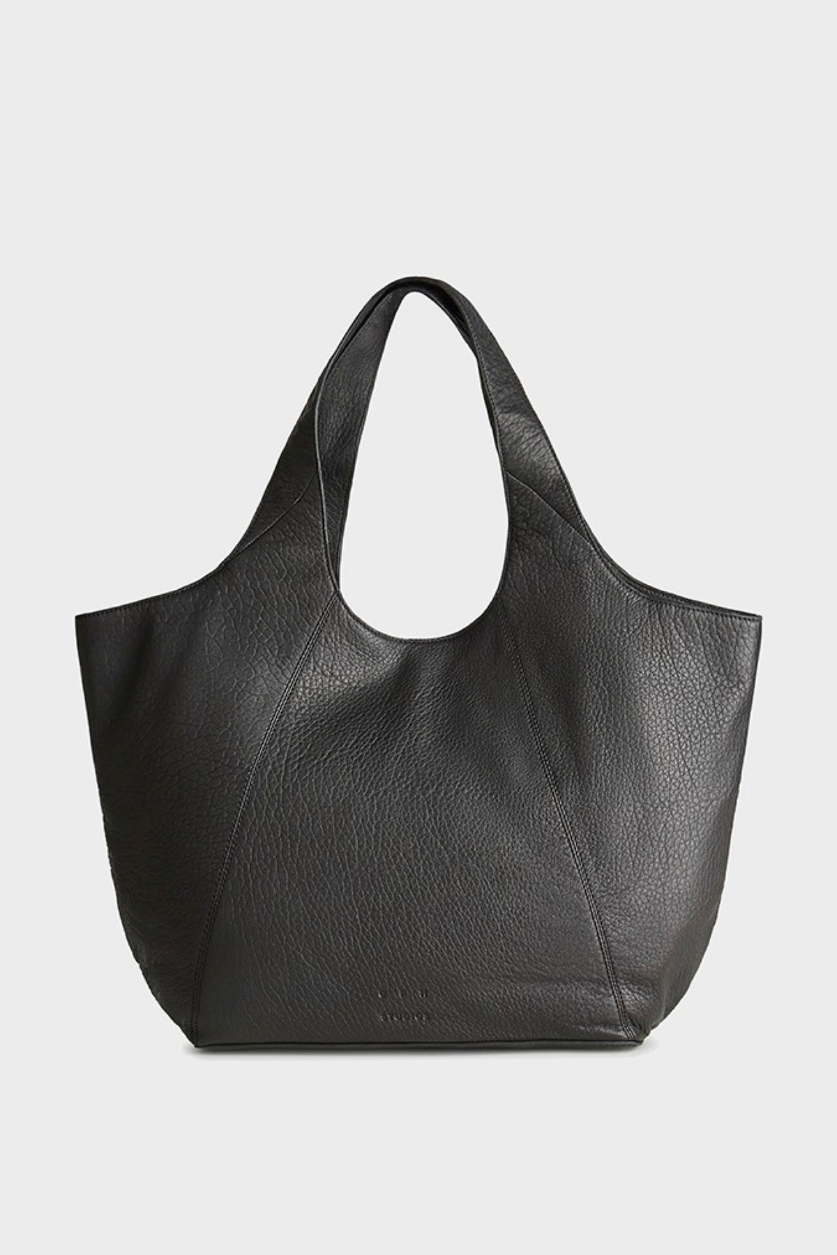 A black pebbled leather tote bag with a wide, open top and two shoulder straps, photographed against a light gray background.