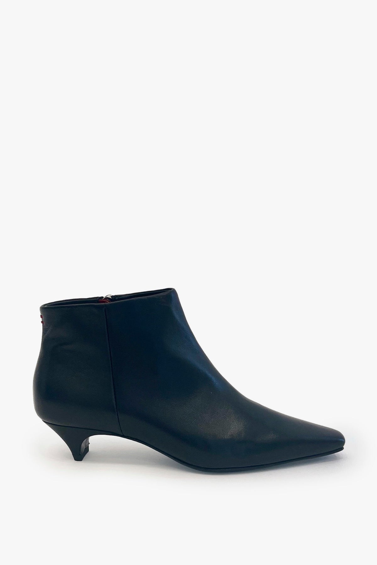 A single black leather ankle boot with a pointed toe and a low kitten heel, shown from a side profile against a plain white background.