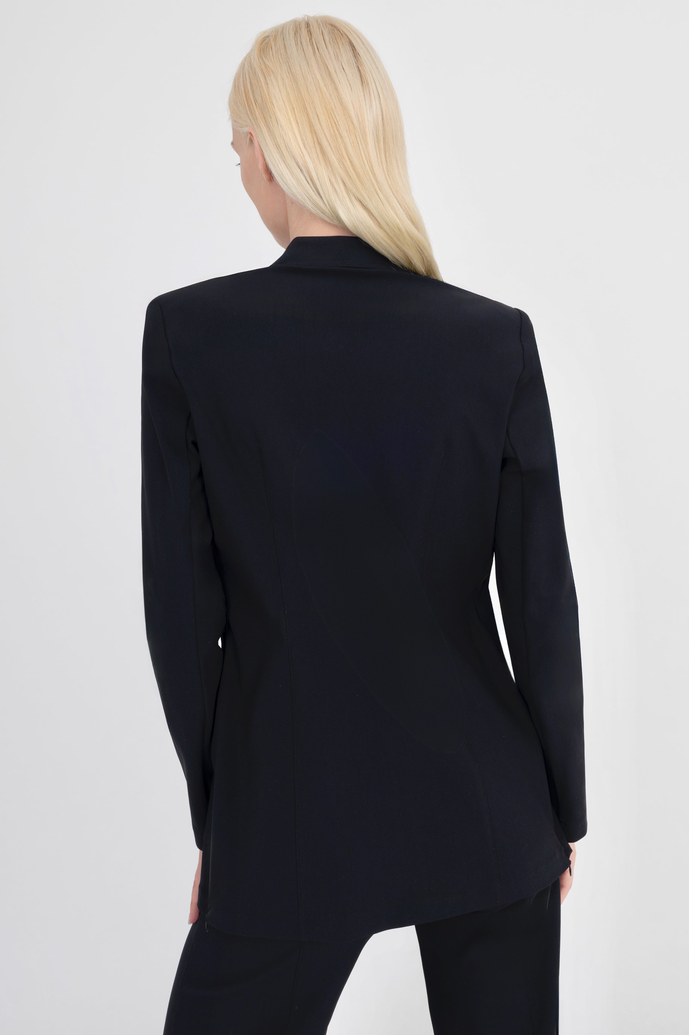 Woman wearing black blazer on a white background