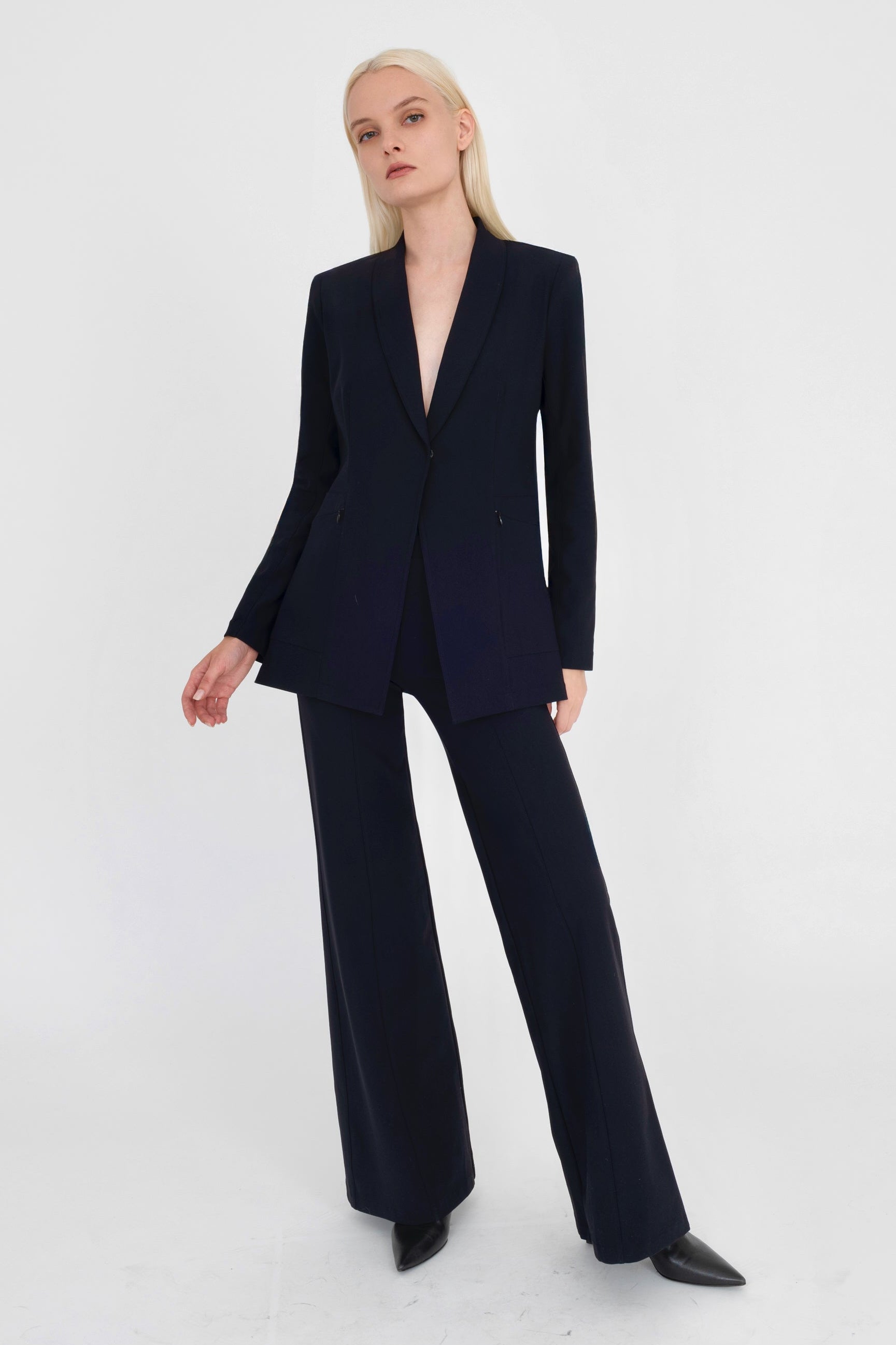 Woman wearing black suit on a white background
