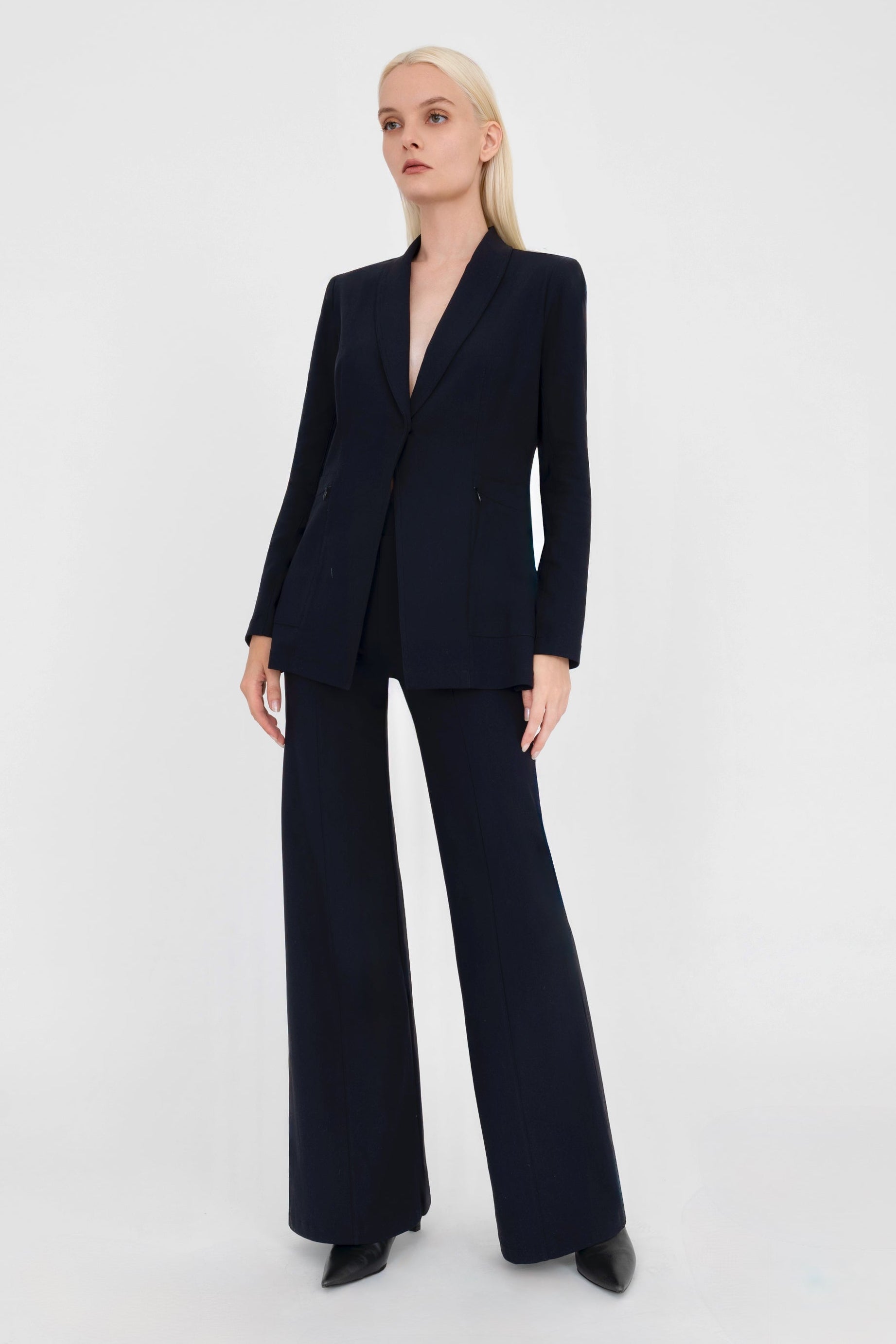 Woman wearing a black suit on a white background