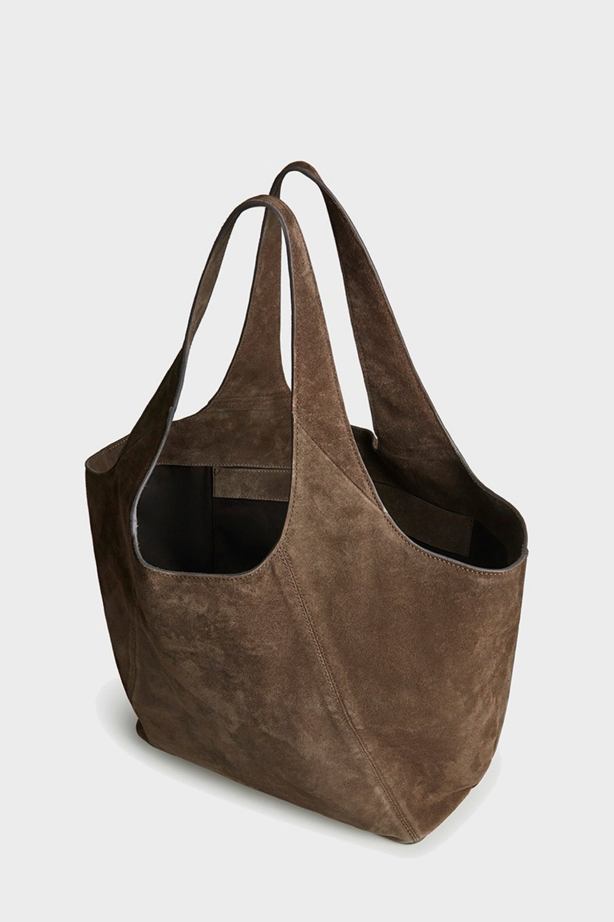 A brown suede tote bag with dual shoulder straps, photographed on a clean light gray background.