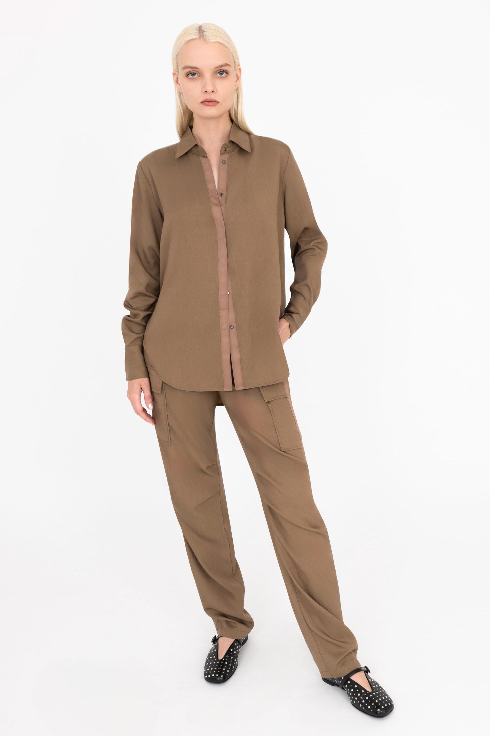 Woman wearing a brown outfit on a white background