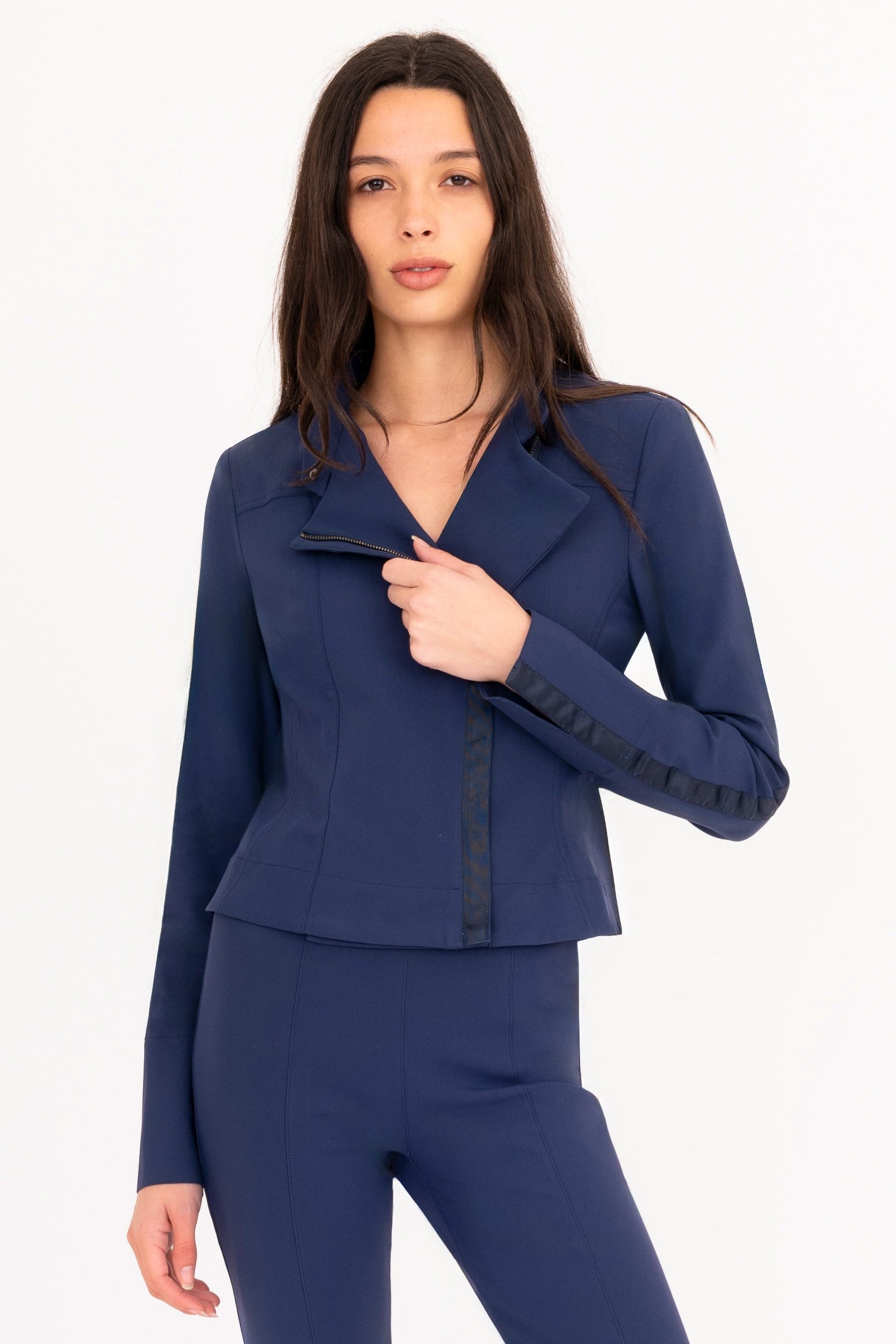 Woman wearing a navy blue outfit on a white background