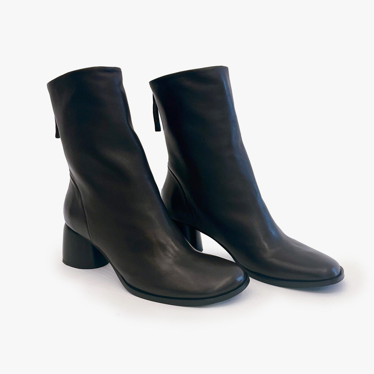 A pair of dark brown leather ankle boots with block heels and round toes, photographed on a clean white background.