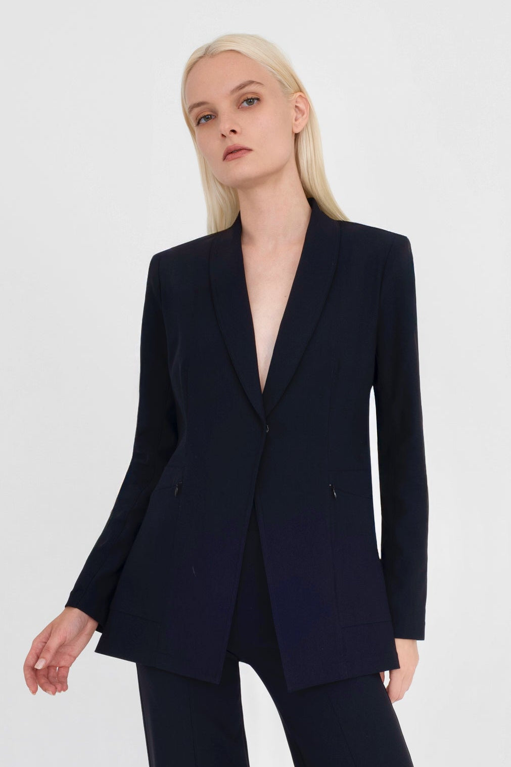 Woman wearing black blazer on a white background