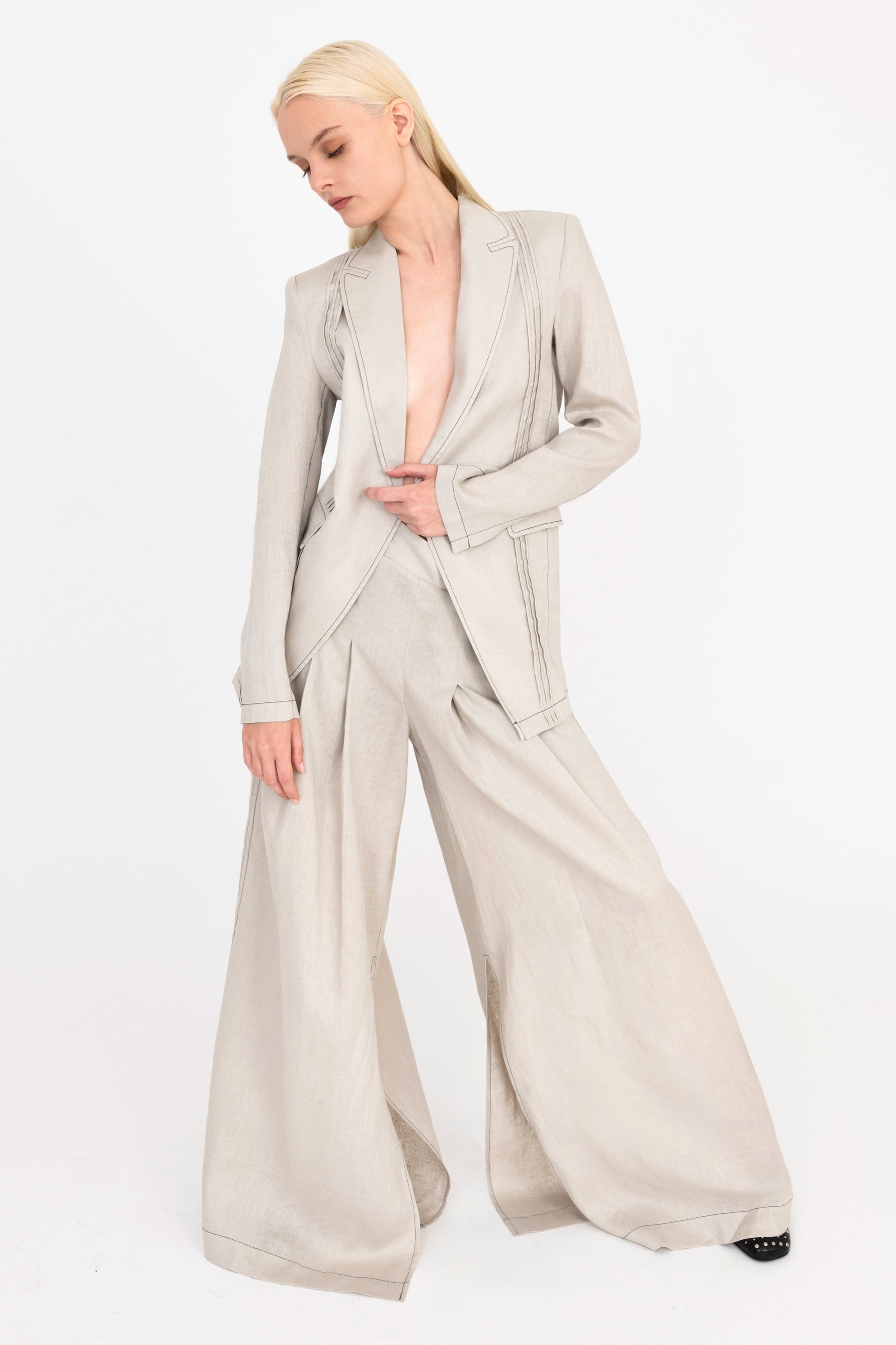 Woman wearing beige suit on a white background