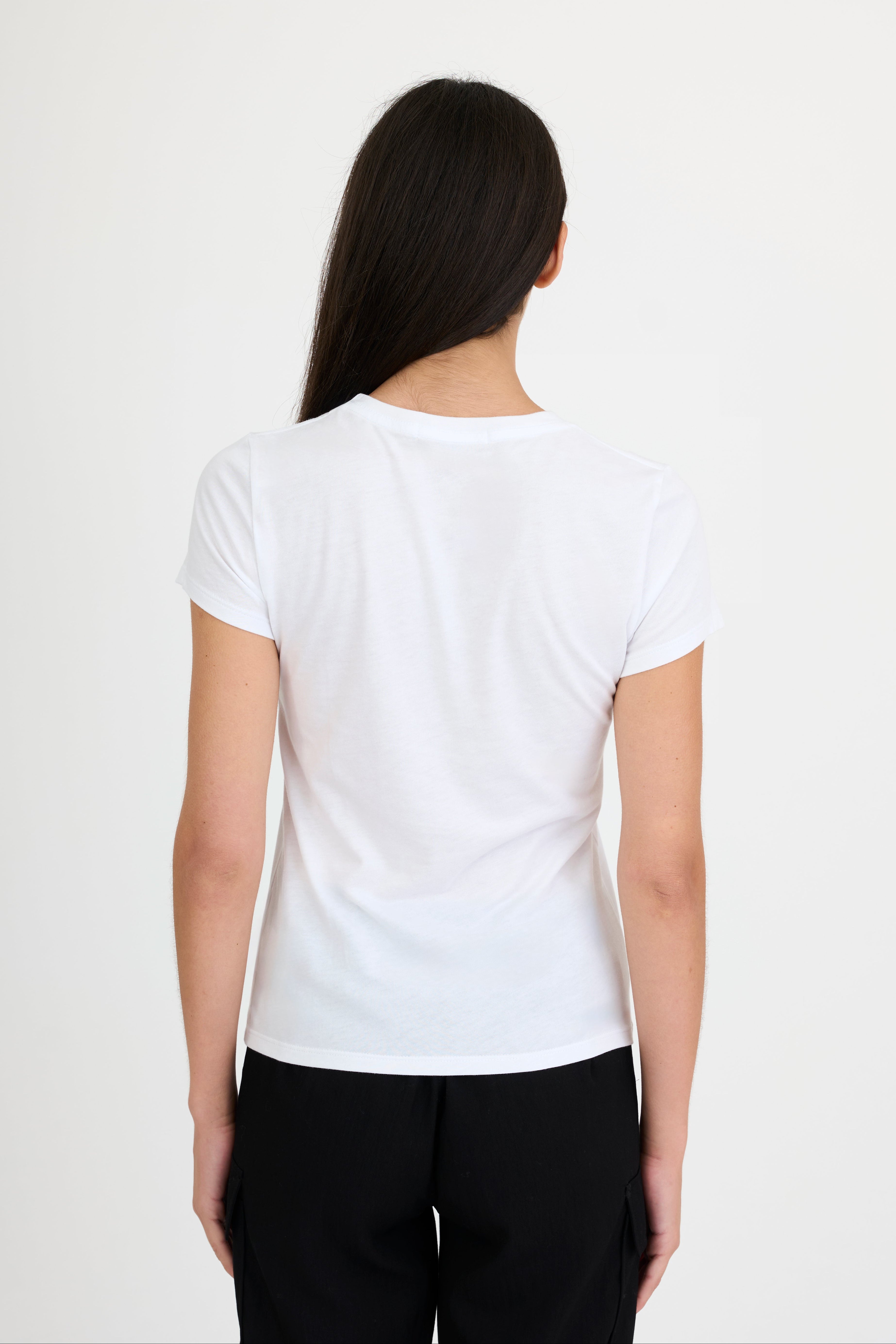 Woman wearing a white t-shirt and black pants on a white background
