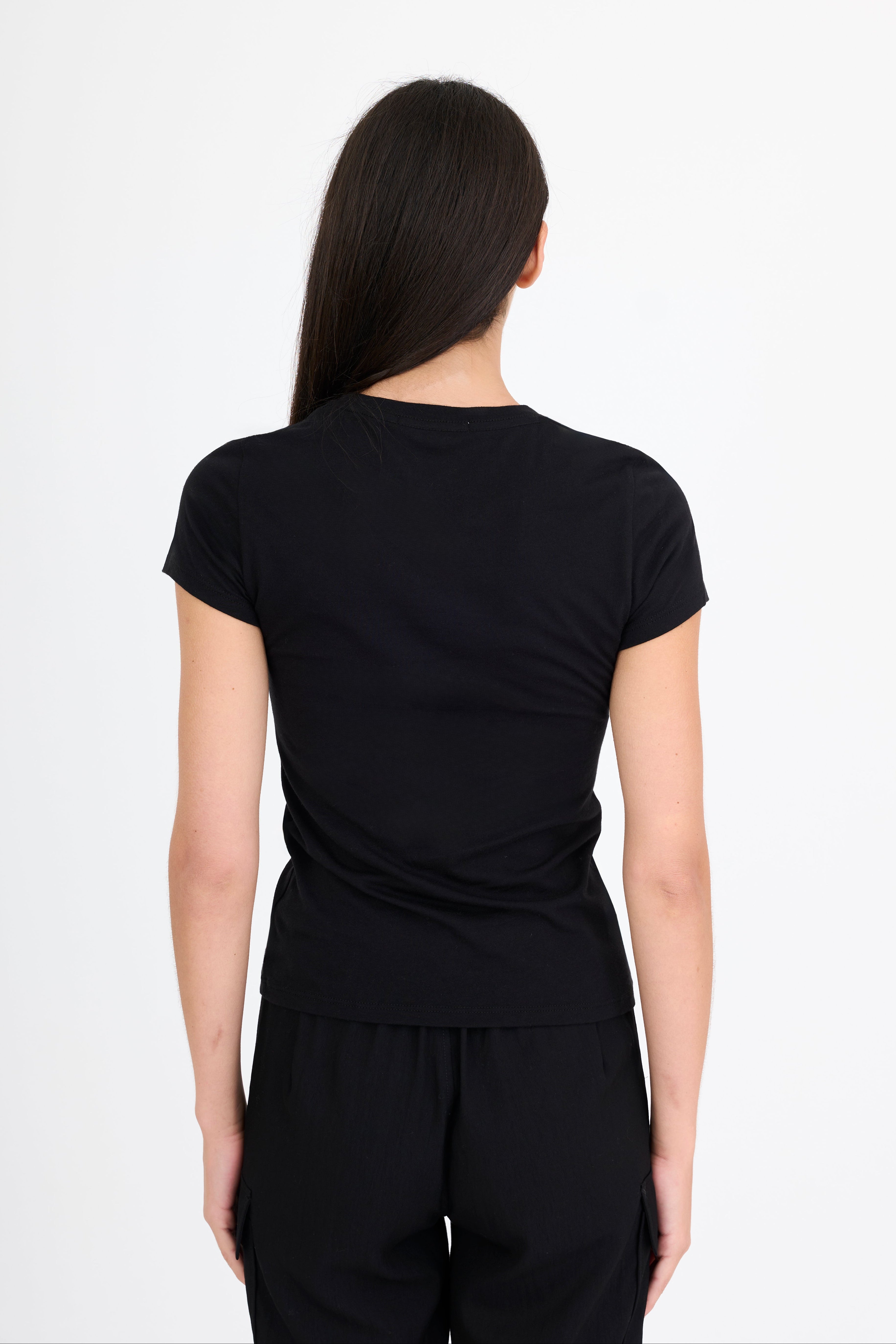 Woman wearing a black t-shirt and black pants on a white background